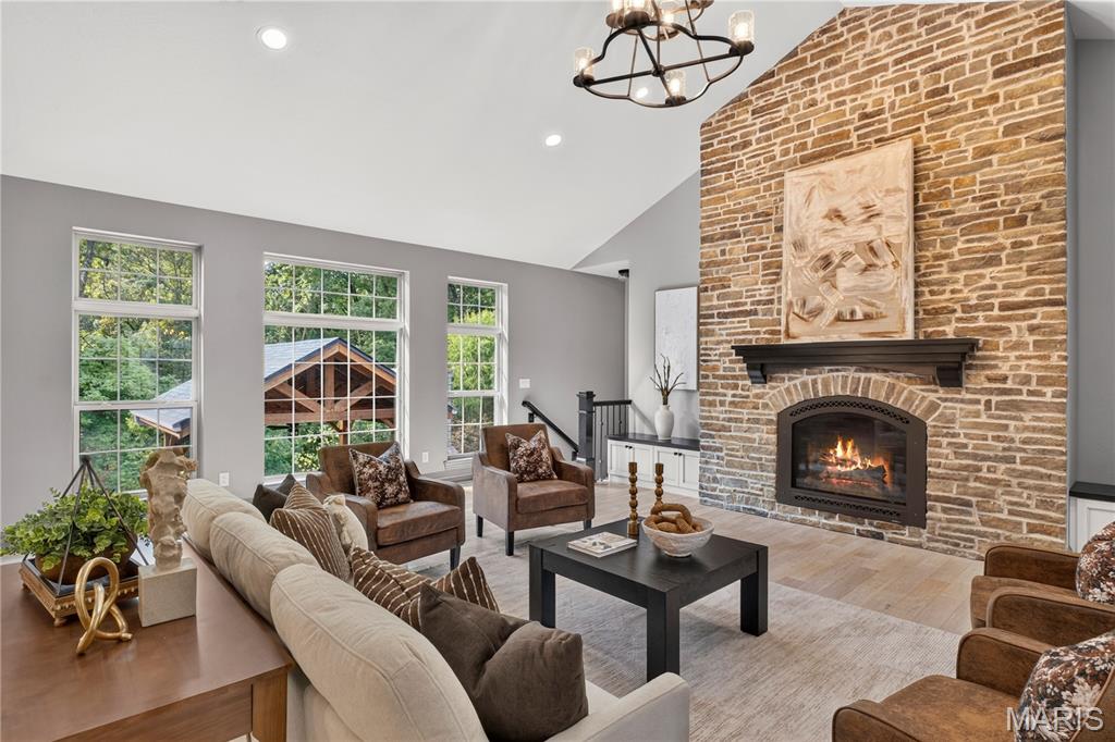 **Exquisite Custom Estate on a Wooded Cul-de-Sac Lot!** This extraordinary 5-bedroom, 4-bath CUSTOM RANCH showcases exceptional craftsmanship, timeless design, and an unmatched combination of luxury, comfort, and versatility. This remarkable residence offers garage space for up to 10 vehicles—an exceptional amenity for collectors, hobbyists, or those seeking the ultimate workshop. The thoughtfully designed OPEN FLOOR PLAN is highlighted by soaring vaulted ceilings, rich hardwood flooring, and a spectacular floor-to-ceiling stone fireplace that anchors the impressive great room. The gourmet kitchen is beautifully appointed with an expansive center island, custom cabinetry, double convection ovens, premium vent hood, Butler's pantry, and designer organizational features, creating a space that is as functional as it is elegant. The MAIN LEVEL offers four spacious bedrooms, including a luxurious primary suite, an oversized laundry room with built-in workspace, and three beautifully finished baths all on the main floor. The walk-out finished LOWER LEVEL is an entertainer's dream, featuring a private home theater, second kitchen, recreation room, bonus room, custom executive office/cigar room with separate exhaust fan, fifth bedroom, fourth full bath, and abundant storage—perfect for hosting guests or multi-generational living. Step OUTSIDE to your own private resort, where a stunning custom pavilion with a grand wood-burning fireplace, gas fire pit, covered screened deck, stamped concrete patio, hot tub, and tranquil wooded backdrop create the ultimate setting for year-round entertaining and relaxation. Every DETAIL has been carefully considered, including geothermal heating and cooling, heated garages with radiant-heated epoxy floors, workbenches, a climate-controlled lower garage with mini-split HVAC, gutter guard, irrigation system, professional landscape lighting, whole-home audio, outdoor speakers with Disney experience, custom roofline lighting, an integrated security system with cameras, and Control4 Home Automation system. Located in one of O'Fallon's most desirable neighborhoods, just minutes from vibrant downtown O'Fallon and Scott Air Force Base, this exceptional residence offers an unparalleled blend of sophistication, privacy, and modern convenience. A truly rare opportunity to own one of the area's finest custom homes. Ask to see the features sheet for more details!
