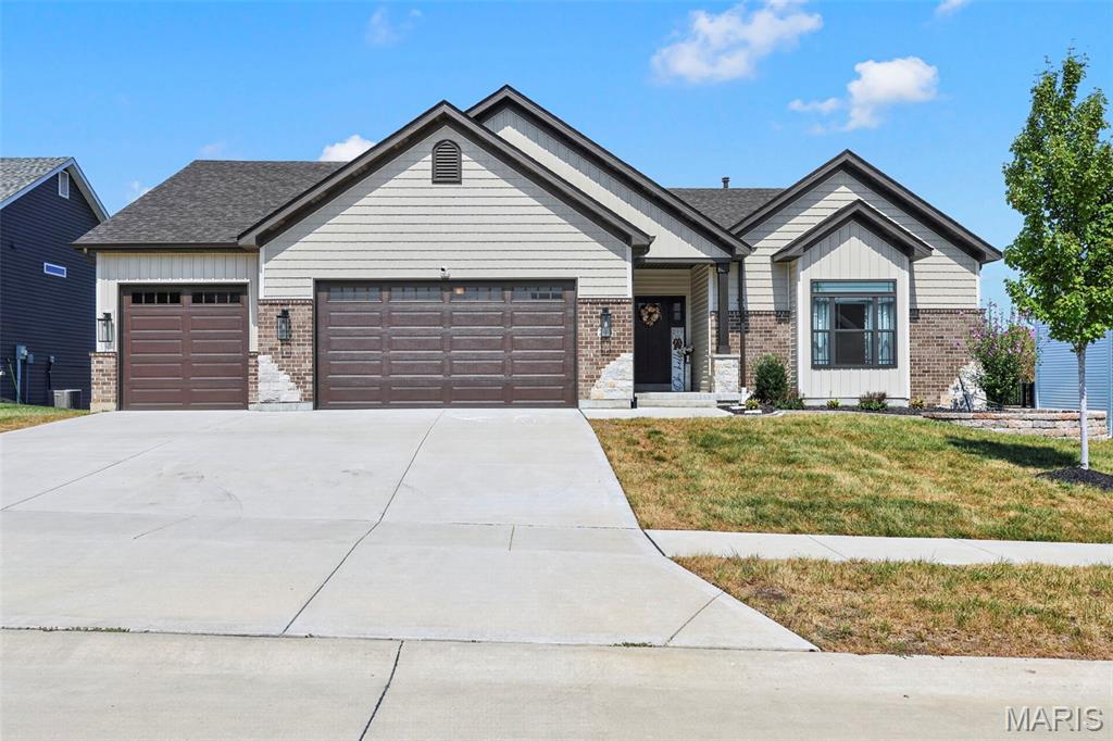 Stunning, like-new 4-year-old ranch with an open, thoughtfully designed floor plan and an incredible OVERSIZED 4-CAR GARAGE! The tandem 3rd bay extends an impressive 40 ft—perfect for multiple vehicles, boat, toys, workshop or extra storage. Inside, the spacious great room features soaring 11-ft ceilings and a wood-burning fireplace with beautiful brick surround, while 9-ft ceilings throughout add to the open, airy feel. The gourmet kitchen offers quartz countertops, 42" soft-close cabinetry and Gallery stainless steel appliances, plus a large adjoining dining area. Retreat to the serene owner's suite featuring a calming color-drenched bedroom and spa-like bath with separate soaking tub and shower, adult-height vanities and tile flooring. Two additional generously sized bedrooms each feature walk-in closets. Enjoy outdoor living on the 14x16 covered deck and patio overlooking the backyard. The full walkout basement offers tremendous potential for additional living space and includes a sump pump/pit and rough-in for a full bath. Move-in ready and ideally located near Hwys 364 & 64, schools, shopping and dining. The space, finishes and RARE 4-car garage make this one a standout!  Hurry it won't last long!