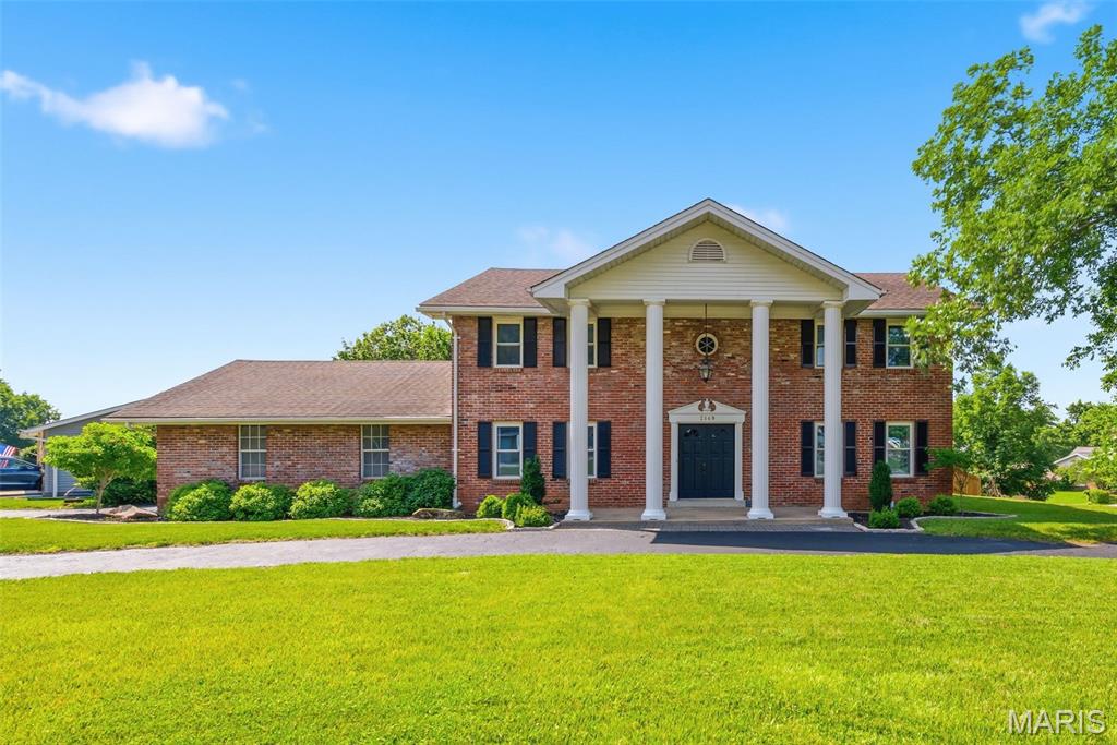 Predominately brick, two story home with 2,740 sq ft of amazing living space in the highly desirable Heritage neighborhood! This home sits on a corner lot with a circular drive and a two-car, oversized, side entry garage (one side is 26.10 deep). The exterior is predominantly brick with vinyl siding in the gables and a stately front porch. Enjoy updates throughout such as quartz countertops, luxury vinyl plank flooring, granite vanity tops in the baths, updated electric panels (2-200 amp panels replaced in 2023) and more.  Features include a two-story entry foyer, staircase with exposed treads, formal dining room with wood flooring and special millwork, main floor Office/Study, updated main floor Powder Room and main floor Laundry Room with access to the backyard and garage. The Great Room has luxury vinyl plank flooring, a wet bar, a fireplace (nonfunctional) with floor to ceiling brick surround and an added width sliding glass door that opens to the rear patio. There is a bay window and built in workstation in the Breakfast Room, the kitchen has quartz countertops, a tile backsplash, a smooth top electric range, dishwasher, microwave, refrigerator and two pantries. Upstairs you will find a huge Primary Bedroom suite with a Sitting Room, fireplace (nonfunctional), french doors that open to a small wood deck, large walk-in closet and an updated Primary Bath with a raised height double bowl vanity, granite vanity tops, tub and shower. There are two additional bedrooms upstairs and an updated bath with a raised height double bowl vanity, granite vanity tops, a tub/shower with subway tile walls and a transom window. The furnace is 6 years old and the AC is 3 years old. The backyard is fenced, is outlined with mature trees and has a large patio. The basement is unfinished except for one finished room, perfect for a home Office, Flex Room or play room. The kitchen refrigerator, washer and dryer stay with the home. Enjoy easy access to Highways I-70, 94/364, parks, the Katy Trail, Lambert International, the Centennial Greenway and more. You are a short commute from Streets of St. Charles Entertainment District and Historic downtown St. Charles. Fantastic home, check it out!