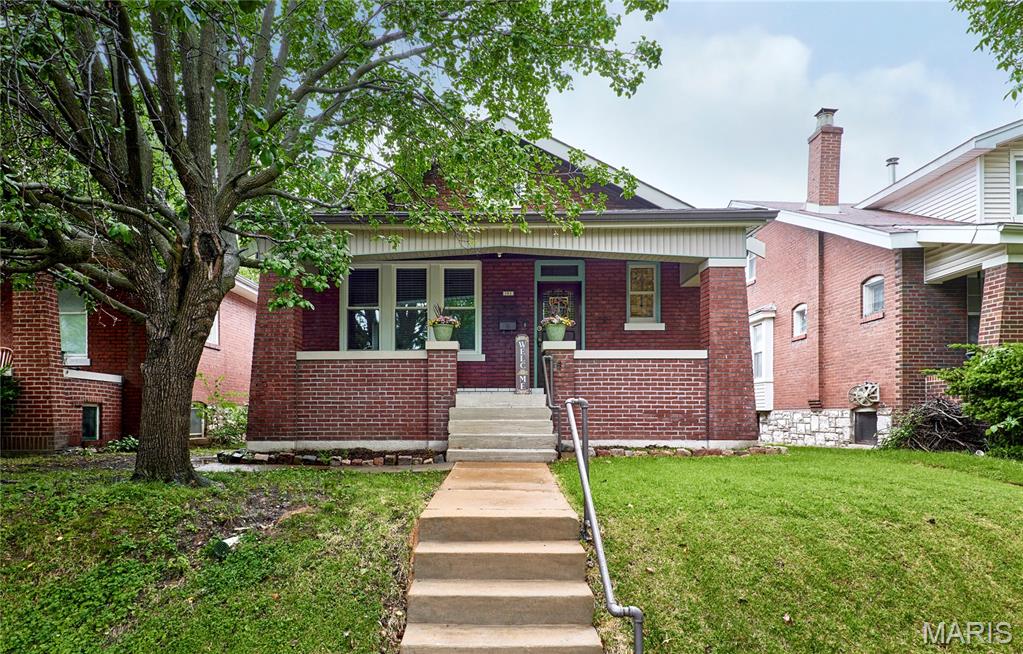 South City charm and modern updates await you in this St. Louis, MO home! This inviting 2-bedroom, 2-bath home offers over 2,100 sq ft of total living space including a partially finished lower level. Upon entering, you’ll notice the cozy drop zone area for coats and shoes including a huge coat/storage closet. The living room features a decorative fireplace, while the living room, dining room, and bedrooms all showcase beautiful wood floors. The separate dining room is filled with natural light and flows into the recently updated kitchen featuring white cabinetry, granite countertops, and stainless steel appliances. Built-in hallway cabinets add both charm and functionality. The updated main-level bath includes new flooring, vanity, and more. The lower level offers additional flexible living space perfect for a family room, rec room, office, or workout area, along with a second full bath and laundry room complete with slop sink and convenient laundry chute from upstairs. Outside, enjoy the deck overlooking the level fenced backyard—ideal for entertaining, pets, or play. Major updates include all NEW WINDOWS in 2023, NEW ROOF in 2022, and NEW WATER HEATER in 2024. Conveniently located near Highway 55, this South City charmer is move-in ready!