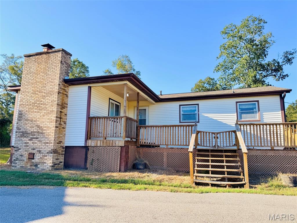 Country living just minutes from Poplar Bluff! This beautiful home sits on 12 acres, conveniently located just down M Highway, offering the peace and privacy of the country while keeping town within easy reach. The home features 2 bedrooms plus an additional non-conforming bedroom/office and a welcoming sunroom. Cozy up beside the real wood-burning fireplace on peaceful winter evenings and enjoy the warmth and unmistakable crackle of a real fire. The primary bathroom offers its own relaxing retreat with a corner jetted tub accented by a custom chandelier, creating an elegant atmosphere perfect for unwinding. Outside, you’ll find a brand-new metal garage/shop with electric, a sturdy pole barn, and a generator for added peace of mind during power outages. The 12 acres offer plenty of room to roam and are alive with wildlife—whitetail deer are abundant! Another great feature is access from both sides of the property, including county road access along the back side. This could provide additional flexibility for the acreage, including the potential for another homesite with separate rear access, subject to applicable requirements. If you’re looking for acreage, wildlife, useful outbuildings, country privacy, and convenient access to Poplar Bluff, this property offers a little bit of everything that makes country living special!