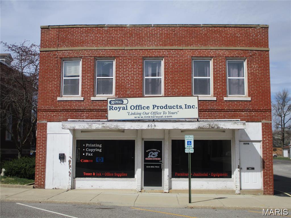 This vacant brick building is one of the prime locations in midtown, next to the Post Office and across the street from the Lory Theatre. Good traffic and visibility. Zoned Improved Commercial, and in a Business District. It has showroom windows up front, and mixed use in rear.  Several business possibilities, with additional 1st floor rental income potential. Upstairs apartment will need improvements before renting.