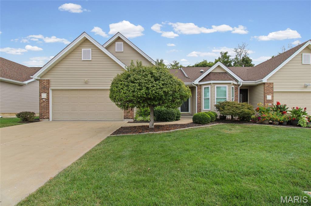 This villa in Arnold's Richardson Glen neighborhood is built for people who are done mowing, done shoveling, and ready to enjoy a minimal maintenance life... free of lawn care, snow removal and exterior upkeep.

Step through the entrance foyer and the vaulted ceilings and rich hardwood floors set the tone right away. The living room opens straight into the kitchen, where a breakfast bar makes morning coffee and weeknight dinners feel like the same easy routine, and the adjoining dining room catches natural light through sliding glass doors and large windows.

Main floor living includes a tucked-away primary suite, with a walk-in closet, a soaking tub, and a separate shower built for slowing down at the end of the day. At the front of the house, a naturally lit office gives you room to actually work from home, run the family calendar, or turn it into whatever your life needs next. Main-level laundry means you're never hauling a basket up or down stairs again.

Head downstairs and the finished lower level opens up to a large recreation room with a wet bar and a second bedroom with an egress window, and a full bath.  This is a fantastic space for guests, family, or a quiet retreat that isn't your main floor. Out back, a private covered patio gives you a spot to unwind without the upkeep. 

Add in the two-car attached garage, and this is a home that trades chores for time.. time you get to spend how you want.

Property comes equipped with a large built-in safe for everything you want to keep secure. As well as a whole home generator to keep the lights (and fridge) on during midwest thunder and ice storms!