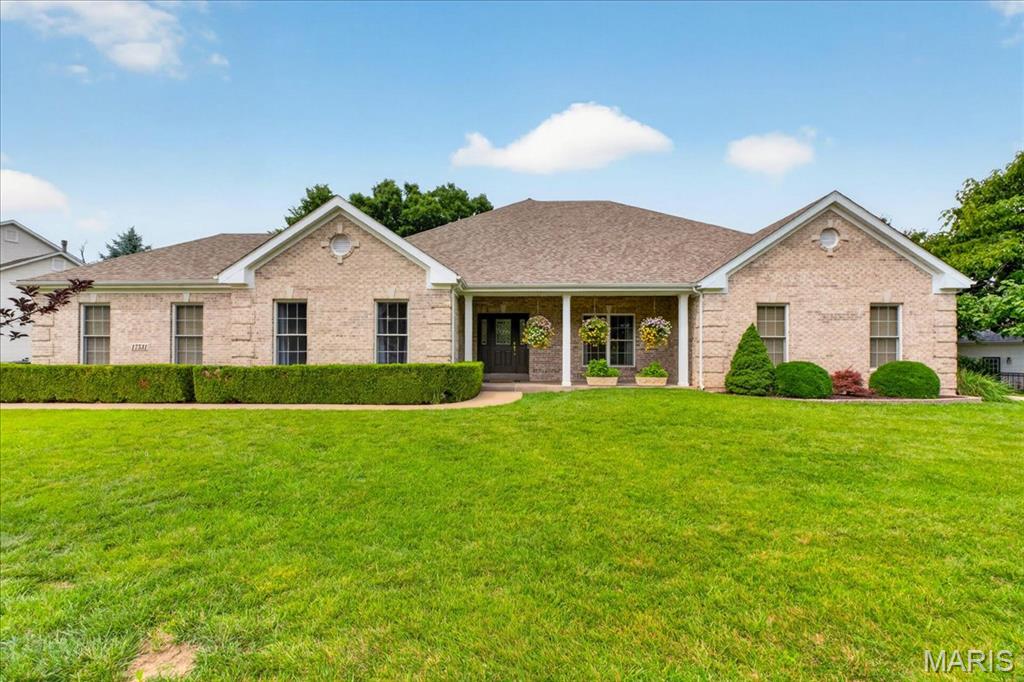 Showings start on Saturday 6/27. Nestled on a half-acre lot backing to woods, this spacious all-brick ranch offers well over 4,000 square feet of finished living space, including almost 2,900 square feet on the main level. A truly unique feature, the home includes two separate two-car side-entry garages located on opposite sides of the residence, each with its own driveway, providing exceptional flexibility for vehicles, storage, hobbies, and guests. A welcoming foyer with 12-foot ceilings, hardwood flooring, and detailed millwork opens to an elegant dining room with a tray ceiling, creating an ideal setting for holiday gatherings and special occasions. The expansive great room features soaring ceilings and hardwood floors, flowing seamlessly into the kitchen with 42-inch cabinetry, granite countertops, abundant workspace, an oversized walk-in pantry, and convenient butler's pantry. The adjoining hearth room with a gas fireplace serves as the heart of the home, offering a warm and inviting space for everyday living. The primary suite is a private retreat with a coffered ceiling, large walk-in closet, dual vanities, separate shower, and soaking tub. A second bedroom and full bath on the main level provide flexibility for guests, family members, or a home office, while a conveniently located powder room and main-floor laundry room enhance everyday convenience. Many rooms have been freshly painted, enhancing the home's bright, well-maintained appeal and making it truly move-in ready. The finished walk-out lower level offers exceptional versatility with a spacious family room featuring a gas fireplace, a full kitchen, two additional bedrooms with walk-in closets, a full bath, and a bonus recreation/sunroom space that can easily adapt to your family's needs. Whether accommodating multi-generational living, extended guests, hobbies, or entertaining, this thoughtfully designed lower level provides room for everyone to spread out and enjoy. Additional highlights include zoned HVAC, steel floor joists, premium Andersen windows, abundant storage, and a beautiful fenced backyard setting backing to trees. Located in the desirable Garden Valley subdivision and served by the highly acclaimed Rockwood School District, this well-maintained all-brick home offers spacious, flexible living in one of Wildwood's most sought-after neighborhoods.