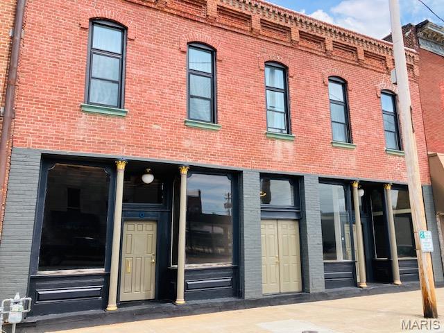 PRICE IMPROVEMENT-Don't miss this! Two Retail Units + Two Apartments + Roof mounted solar panel system for utility savings. Own a piece of history with this beautifully renovated 1897 Italianate brick building the in the heart of downtown. Offering 4,500 total square feet, this fully updated property blends vintage charm with modern upgrades-perfect for owner-occupants, investors, or those seeking income-generating potential. Live above and lease below, or launch your own business in one of the stylish commercial spaces. Each storefront features soaring ceilings, tall display windows, and timeless architectural character. Spacious 1600 sq ft 2-Bedroom Apartment upstairs with ornate tin ceiling, updated kitchen, 2 baths and private access. Separate Efficiency Apartment, ideal for guests, tenants, or short-term rental income. Energy-efficient and move-in ready, this is your chance to own a fully restored historic building with flexible living, busines, and rental options. All units are currently vacant, offring flexibility for the new owner to hand-select future tenants or customize occupancy to suit their investment or personal use goals.