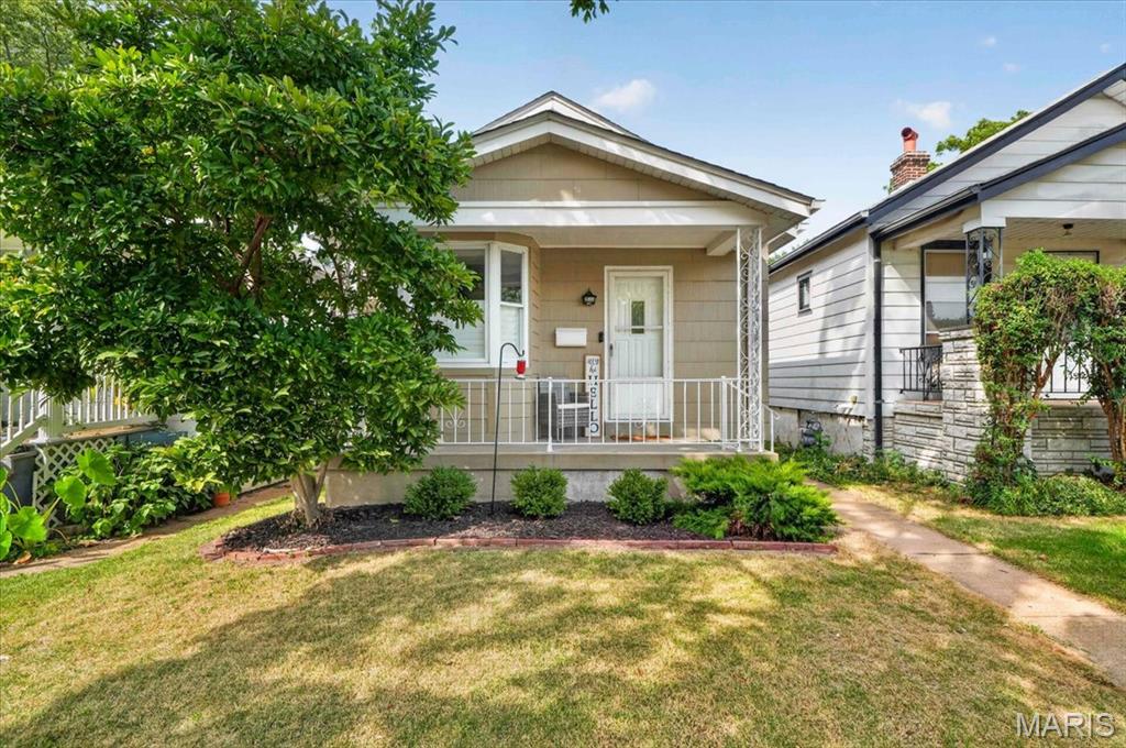 Why pay rent when you can own this cute South City bungalow?! From the moment you arrive, you’ll love the curb appeal and covered front porch—the perfect spot to enjoy your morning coffee or unwind with a glass of wine.  Step inside to find beautiful hardwood flooring throughout, charming stained-glass windows and vintage sconces that add character and warmth. The inviting living room features an adorable bay window seat, creating the perfect little nook to curl up with your favorite book.  The updated kitchen combines style and function with 42-inch white shaker cabinets, stainless steel appliances, and quartz countertops. The updated bathroom adds another modern touch while complementing the home’s classic charm. Just off the kitchen, the sun porch offers a peaceful place to relax after a long day while overlooking the level, fenced backyard. The unfinished, walk-out lower level provides plenty of opportunity to create additional living space, a home office, gym, rec room, or whatever fits your needs. The garage adds convenient off street parking while the home’s location puts you just minutes from several parks, restaurants, and major highways. Classic South City charm, thoughtful updates, and room to make it your own—this one is ready to welcome you home!