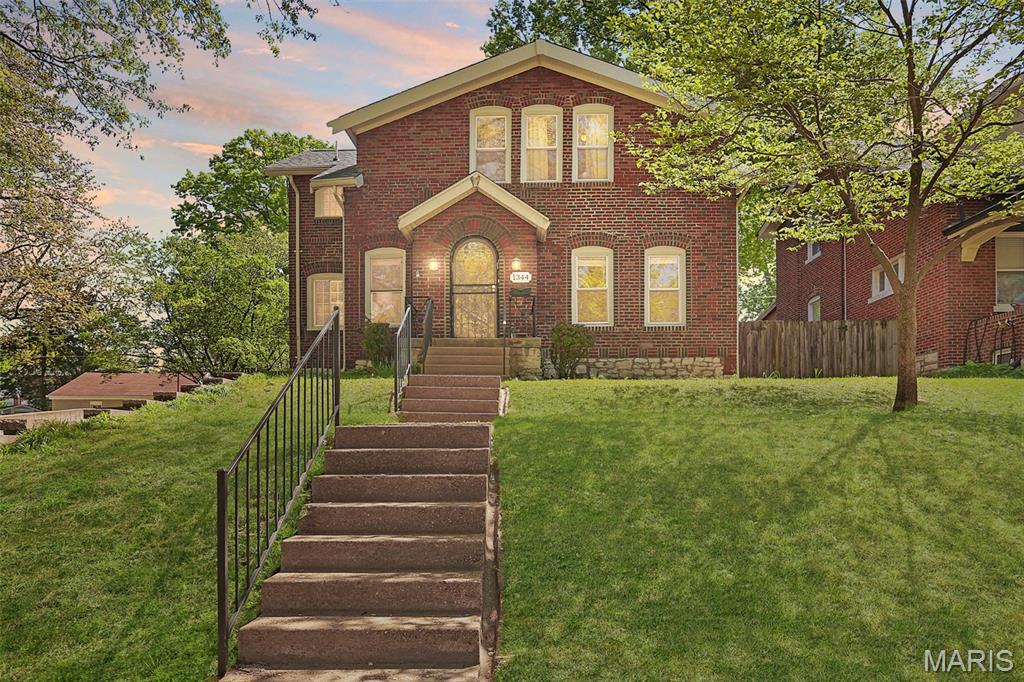 Welcome to this charming all-brick 2-story home in the heart of University City, where timeless architectural details blend seamlessly with thoughtful modern updates. From the moment you arrive, you'll appreciate the character and curb appeal that make this home truly special. Inside, beautiful hardwood floors, arched doorways, stained-glass accents, and abundant natural light create a warm and inviting atmosphere throughout. The spacious living room serves as the heart of the home, featuring a classic fireplace flanked by built-ins, crown molding, and plenty of room to gather with family and friends. Just off the living room and entryway, you'll find a versatile little bonus space that would be perfect for a children's play area, reading nook or home office. The formal dining room offers the perfect setting for entertaining and flows effortlessly into the kitchen, complete with granite countertops, stainless steel appliances, tile backsplash and ample cabinetry. A convenient main-floor half bath adds functionality for guests and everyday living. Upstairs, you'll find the spacious primary bedroom ensuite featuring a walk-in closet, double vanity, modern finishes, and a tiled glass-enclosed walk-in shower. You'll also find 2 additional bedrooms and an updated full hall bath with a shower/tub combo. The lower level expands your living space and offers flexibility for a recreation room, playroom, home office, workout area, media space, or additional storage. Step outside to discover an outdoor retreat designed for both relaxation and entertaining. The covered back porch provides the perfect spot to enjoy your morning coffee or unwind in the evenings, overlooking the expansive backyard. A large patio offers plenty of space for outdoor dining and gatherings, while the level yard provides room for play, pets, gardening, and more. Garden beds and mature trees add charm and privacy, creating a peaceful setting to enjoy throughout the seasons. Completing the outdoor space is a detached brick garage with additional driveway parking. Conveniently located near parks, restaurants, shopping, Washington University, Clayton, and major highways, this University City gem offers the perfect blend of historic character, modern comfort, and everyday convenience.