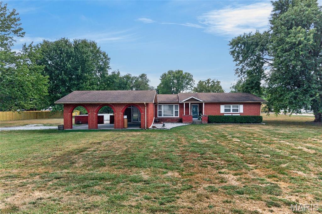 Looking for a charming all-brick home with character & space??? Welcome home to this charming all-brick residence featuring 3 bedrooms, 2.5 baths, and over 1,500 square feet of comfortable living space, situated on a spacious lot in the Joel E. Barber School District. Beautiful hardwood floors flow through the living room and hallway, adding warmth and timeless character throughout the home. The inviting living room features a fireplace with an electric insert, while the kitchen offers white cabinetry and granite countertops, creating a bright and welcoming space for everyday living and entertaining. The spacious primary suite provides a relaxing retreat with his-and-her closets and a connected bathroom featuring his-and-her vanities and a tiled shower. A true highlight of this home is the large sunroom/bonus family room, complete with a wood-burning fireplace and plenty of space for gathering, relaxing, or entertaining. The sunroom opens directly to a charming, enclosed courtyard, which then provides access to the enclosed two-car carport—creating a unique and convenient flow between the indoor and outdoor living spaces. Outside, the generous lot offers plenty of room to enjoy the outdoors, while the enclosed courtyard provides a cozy, private area for relaxing or entertaining. With its classic brick exterior, beautiful hardwood floors, two fireplaces, spacious primary suite, versatile sunroom, charming courtyard, and convenient enclosed two-car carport, this home offers a wonderful combination of comfort, character, and functionality.