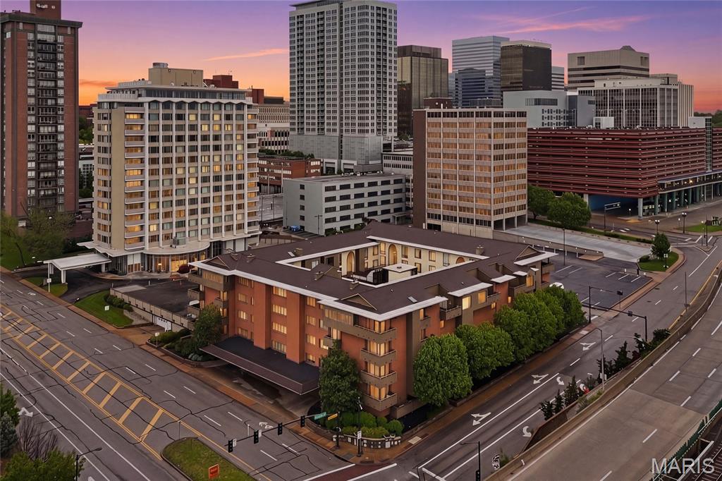 Elegant, renovated, and exceptionally spacious, this 2,082 sq ft first-floor condo at Shaw Park Place offers rare one-level living directly across from Shaw Park in the heart of Clayton. With a flexible floor plan, generous room sizes, multiple outdoor spaces, and a premier walkable location near downtown Clayton, this home delivers the space, convenience, and low-maintenance lifestyle today’s buyers want.

Fresh paint throughout, updated flooring, renovated bathrooms, and new appliances create a clean, move-in ready feel. The kitchen features granite countertops, ample cabinetry, pantry storage, and brand-new stainless steel range/oven/cooktop and over-the-range microwave. A full-size dining room, large living room, family room with wet bar, and dedicated flex room provide outstanding versatility for entertaining, working from home, hosting guests, yoga, exercise, or a quiet retreat.

The layout includes 2 bedrooms, 2 full baths, in-unit laundry with washer and dryer, crown molding in many rooms, and a beautifully renovated main bathroom with a walk-in glass shower. Three private exterior decks, including access from the kitchen and bedroom areas, extend the living space and offer views toward Shaw Park and the surrounding Clayton streetscape. Select interior rooms also overlook the landscaped atrium courtyard, adding natural light and a peaceful sense of setting.

Additional highlights include secured building access, attentive on-site maintenance crew, elevator service, assigned covered garage parking, guest/off-street parking, private storage room, party/recreation room, and inviting courtyard gathering areas. Enjoy everyday convenience just moments from Shaw Park trails, tennis courts, pool, pickleball, playgrounds, Clayton Community Center, Meramec Elementary, Wydown Middle, Clayton High School, downtown Clayton restaurants, cafes, shops, galleries, MetroLink, I-170, I-64, Washington University, Forest Park, BJC, and Lambert Airport.

A standout opportunity for buyers seeking a spacious Clayton condo with outdoor living, garage parking, updated finishes, flexible living space, and an unbeatable location across from one of the area’s most loved parks.