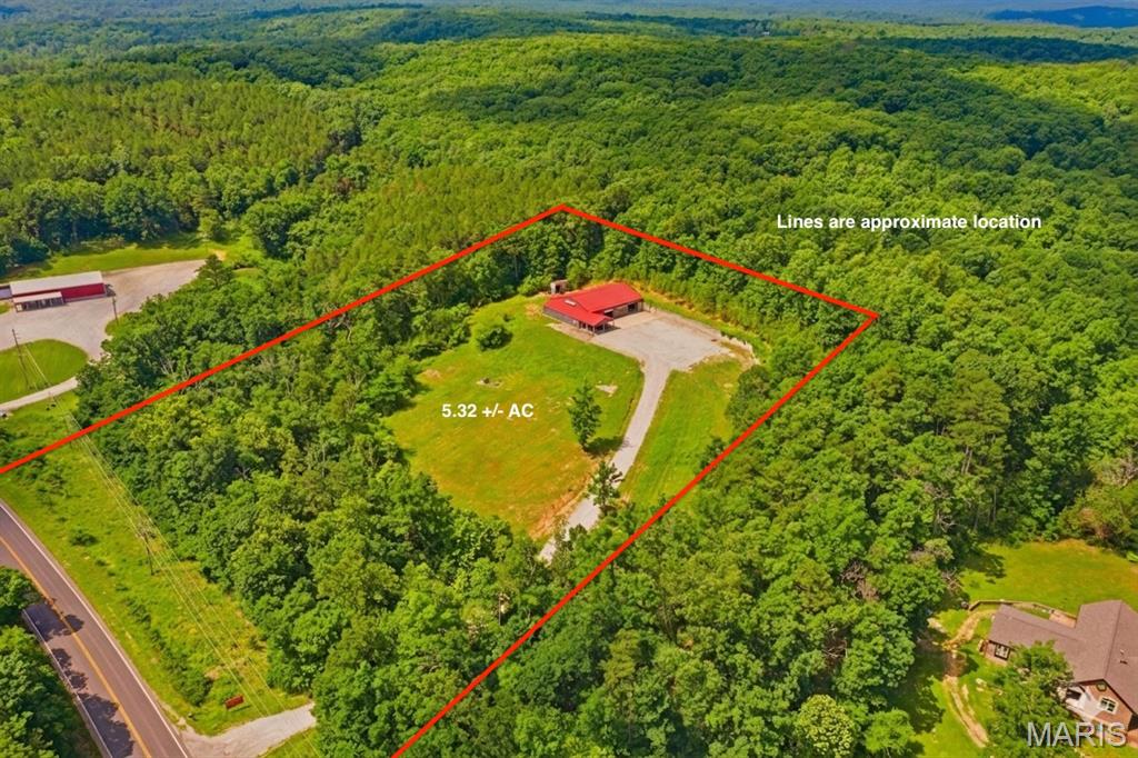 Endless possibilities await with this prime commercial property located just 1.3 miles from the Potosi city limits! Situated on 5.32 acres with NO RESTRICTIONS, this property is a blank canvas for your business or development dreams. Built in 2018, the main building features a massive 50x80’ clear-span shop floor (4,000 sq ft) with two large overhead garage doors. Currently utilized as a successful auto body repair shop, it comes fully equipped with a built-in spray booth and professional air lines ran throughout. Front of building boasts an approx. 800 sq ft climate-controlled office, waiting area, restroom, and a convenient attached 2-car carport for shaded customer parking or outdoor workspace. The property features a massive parking lot with seamless ingress/egress—perfectly designed for easy large truck navigation, heavy equipment maneuvering, or outdoor storage. With over 5 acres of unrestricted land, there is immense room for fleet parking, expanding operations, or adding secondary structures. Whether you want to step into a turn-key automotive facility on Day 1 or repurpose the site for logistics, manufacturing, or retail, this location delivers. Schedule your tour today!