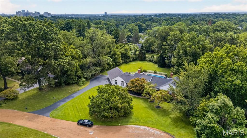 Welcome to 11 High Acres Drive, an extraordinary 1.5-story traditional estate nestled on a sprawling, private 1.46-acre cul-de-sac lot in the heart of the top-rated Ladue School District. Boasting over 5,100 square feet of total luxurious living space, this property offers the perfect blend of elegant scale, modern comfort, and eco-friendly efficiency—highlighted by custom rooftop solar panels (2023) to significantly offset energy costs. New roof, gutters, and downspouts installed in 2023.
 
Inside, discover the separate dining room, leading into the living room that flows into the den featuring a wood burning fireplace.  Continue into a massive entertaining area with exceptional architectural details including custom cabinetry, cathedral ceilings, special millwork, another woodburning fireplace with mantle, and a custom bar with a wet sink.

Beautiful hardwood and luxury vinyl flooring flow throughout the house (2020). The gourmet eat-in kitchen features granite countertops, custom built in cabinets, a center island, professional Thermador stainless steel appliances, and an open layout ideal for seamless entertaining. 
 
Step outside to your private resort-style oasis. The main level opens to a massive screened-in back porch, leading to an expansive outdoor space with freshly tiled patio areas (2026), a painted pool deck (2024), and an in-ground pool complete with a new filter, motor, and cover (2025).  Beyond the pool lies a massive, lush backyard with an included playset. 
 
Additional features include 5 spacious bedrooms all with plantation shutters, 3 full baths, and 2 half baths, dual laundry locations (basement and off the pool deck entrance), a lower level perfectly suited for a home gym with walk-out, an attached 2-car garage, and 3-zoned HVAC systems (updated 2024 & 2026).

This is truly the one you have been looking for, with such close proximity to everything, but tucked away on a tree lined street, with only 15 houses on the lane, for ultimate privacy.