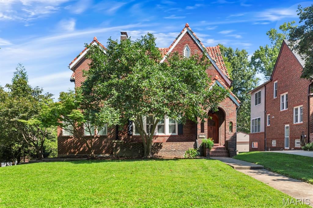 Steal this deal!

A popular location near Clayton and Wash U, combined with 1926 craftsmanship, creates this desirable, charming, and functional home. Spacious, well-maintained, and thoughtfully updated, this three-bedroom, 3.5-bath home blends historic character with modern convenience. Architectural English Revival style mixes with touches of Gothic Revival at this clay tile-roofed brick and stone residence. Starting at the covered brick front porch and arched entry door, enter and soak in the comfortable spaces. Wood floors and crown molding stand out as natural light floods the rooms. Plantation shutters throughout the home protect your privacy and beautifully filter the sun on hot St Louis days.   The living room features a brick fireplace, never used by current owner but appreciated for the focal point it provides, flanked by arched built-in shelving. The dining room adjoins that space and is centered on the main floor. The West wing of the home is a newer addition, expanding the home with a huge, bright family room or entertaining space, as well as a bright study/den/office/playroom. But, oh, the kitchen! L-shaped, it includes a built-in banquet seating area, wet bar, gas cooktop with gorgeous hood, double wall convection ovens, two sink areas, microwave, and refrigerator. It is a well-appointed large kitchen with granite counters and loads of beautiful light-toned wood cabinets. The kitchen opens to a teak wood deck, featuring a privacy screen and built-in gas grill, ready for relaxing, and entertaining. The exterior doorway and grill are set into a beautiful stone surround.

Upstairs, two bedrooms and a full bath occupy the original home space. The addition added a large walk in closet area and primary suite with custom tiled bath. Again, windows and plantation shutters feature prominently, and vintage glass doorknobs add sparkle to the space with history and grace.

The basement offers storage, a full bath, and two flex spaces, one with a wet bar, that can be tailored to your needs, perfect for entertaining, home gym, guest room, or additional living space.  The walk-out lower level opens to the atrium, offering a versatile space to suit your wishes, and is serviced by a Split hvac system
.
The level backyard is surrounded by a beautiful, wrought-iron fence, and the detached brick garage offers secure parking with safe and easy side street access via the remote-controlled gate.

For peace of mind, mechanical systems are newer and solid and the roof is in good condition. A Woods waterproofing install keeps the lower level dry and protected through the worst challenges of STL storms.

Open houses scheduled Friday, August 28 happy hour, Saturday & Sunday, August 29-30, 1-3.