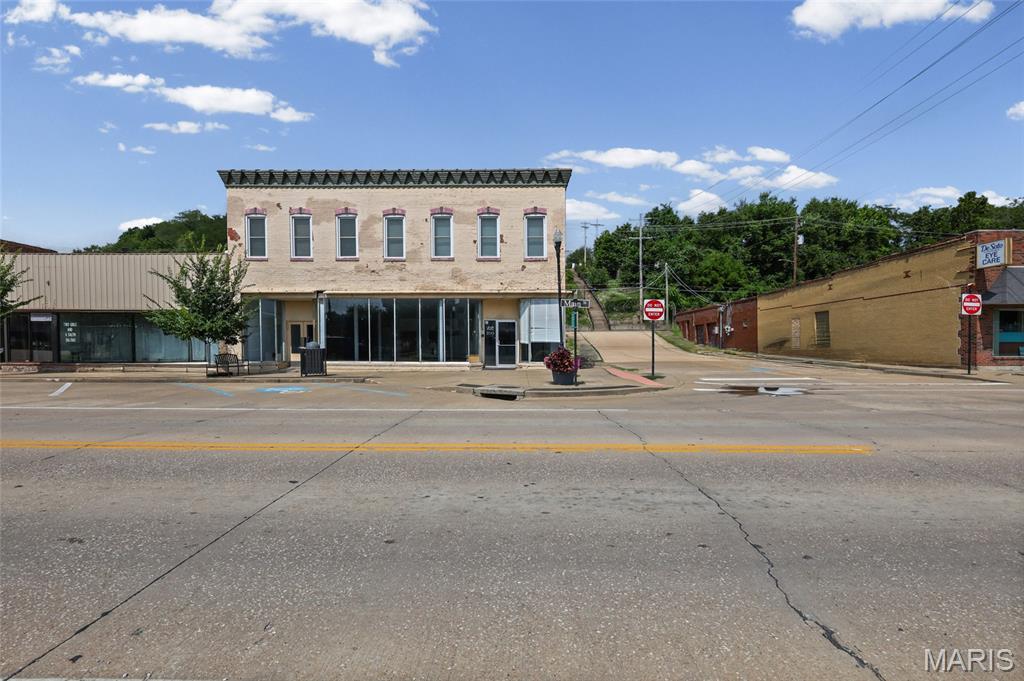 Excellent leasing opportunity in a highly visible downtown De Soto location. This 3,000+/- square foot commercial space offers exceptional frontage along Main Street with an expansive wall of storefront windows, providing outstanding visibility, excellent signage opportunities, and abundant natural light.

The property features an open and versatile floor plan with three half bathrooms, making it suitable for a wide variety of commercial uses. Previously operated as a children's play center, the space can easily be adapted for retail, office, medical, fitness, professional services, showroom, or other approved commercial uses.

Situated in a high-traffic area with strong street presence, this property provides an excellent opportunity for businesses seeking a prominent location in the heart of De Soto. Offered as a Triple Net (NNN) lease
