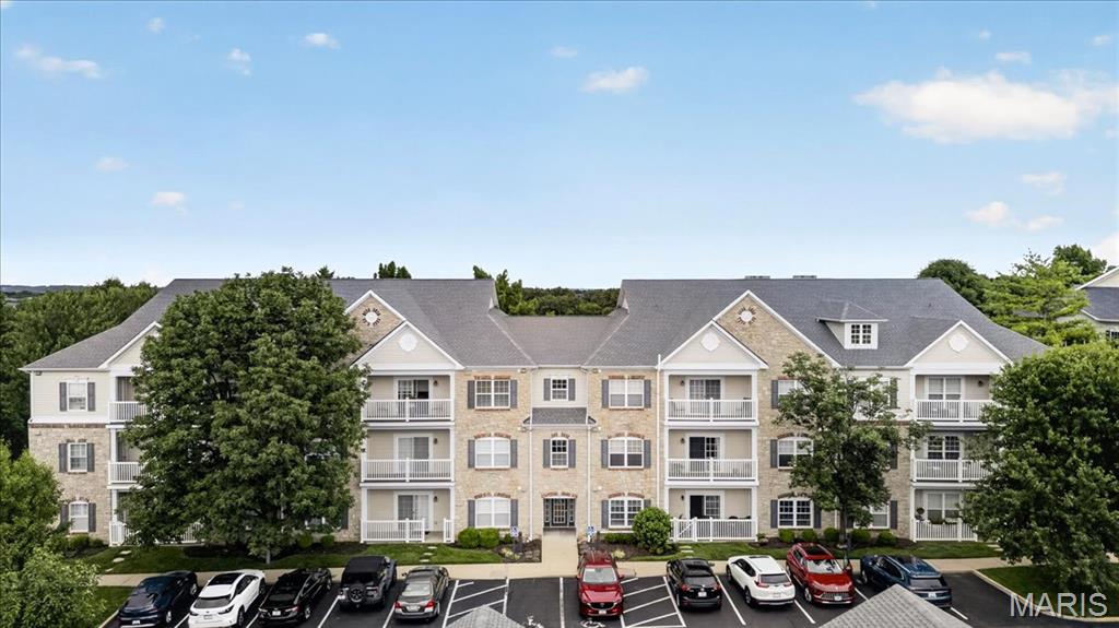 Welcome home to this stunning, move-in ready condo perfectly positioned in the heart of Chesterfield. As a premium end-unit, this home offers a sense of privacy and peace, featuring large windows that frame beautiful wooded views and flood the space with natural light.

The open floor plan flows seamlessly, anchored by a spacious great room with gleaming hardwood floors. An elegant arched entryway leads you into the updated eat-in kitchen, a true standout with crisp white cabinetry, granite countertops, a newer refrigerator, and a center island with a breakfast bar—ideal for a quick morning coffee or evening entertaining.

Retreat to the primary suite, which feels like a private sanctuary with its sophisticated coffered ceiling, large walk-in closet, and an ensuite bath . The second full bathroom is equally impressive, boasting a deep soaking tub perfect for unwinding. A generous second bedroom and a full-size laundry area add to the home’s effortless functionality.

Step outside to the covered porch to enjoy the fresh air and lush surroundings. This unit also includes a designated covered parking spot and a private storage unit for added convenience.

The location is second to none. You are just moments away from the vibrant energy of Central Park and the Amphitheater, with endless options for shopping and dining right nearby. Plus, with quick access to Highway 40, your commute or weekend getaway is a breeze. Experience low-maintenance living at its finest in this exceptional Chesterfield gem.