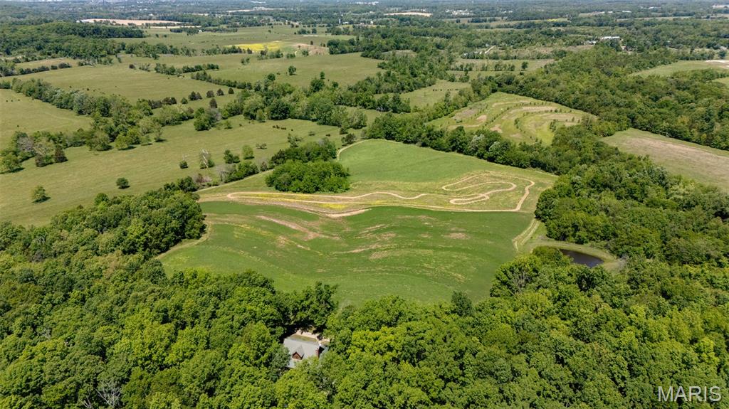 INCREDIBLE 87 acre m/l immaculate farm/recreational retreat close to Farmington. Custom Main home is a 3 bedrooms, 2 1/2 baths with additional living space and bathroom above detached garage. Home has custom hickory cabinets, granite countertops, an in home vacuum system, and one of a kind fixtures throughout. Enjoy the large wrap around porch overlooking terraced rolling pasture which offers farming opportunities and beauty. Additional shed can be used for a garage. This stunning property features a pond and plenty of shaded areas for entertaining that includes a kid's playhouse and custom fire pit. Relax with family and friends on cool evenings around the fire. The property is a mix of pasture, tillable acreage, and established woods that have not been logged in over 100 years. Wildlife galore, monster bucks, and turkey populate the area (The proof is on the walls!) Would make a great hunting retreat/lodge! Second original home is currently used as a rental and has been completely renovated! Large animal barn/ shop has stalls, room for equipment and more!  This AMAZING farm is Minutes from Farmington surrounded by generational farms, this property presents an opportunity for farm, recreational, and homesite uses.