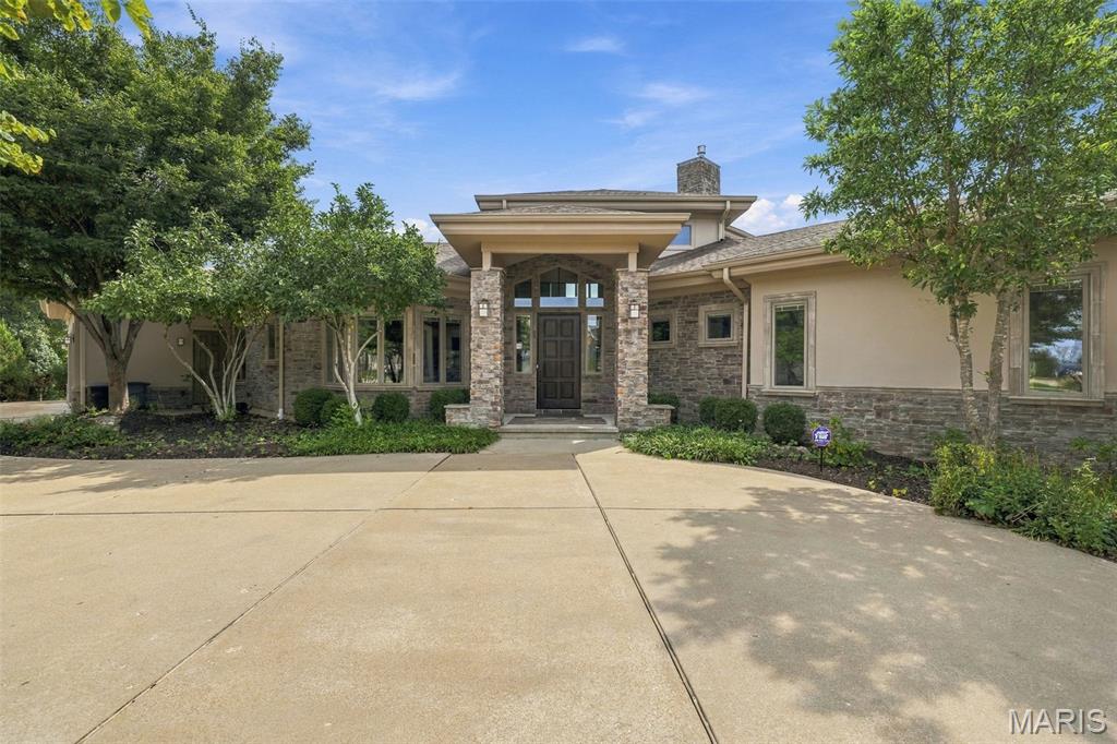 Welcome to this exceptional home in The Arbors, one of Des Peres’ most desirable and established communities. Ideally positioned on one of the neighborhood’s premier lots, this residence offers beautiful views, exceptional space and a thoughtful floor plan designed for both everyday living and effortless entertaining.

From the moment you enter, beautiful hardwood floors and expansive windows draw you toward the incredible views and lush surroundings. The open-concept main level features a spacious great room with a floor to ceiling stone gas fireplace and walls of windows, seamlessly connected to the dining room. Just beyond, the state-of-the-art kitchen is truly the heart of the home, featuring a large island, eat-in area and an impressive suite of Wolf, Sub-Zero and Asko appliances. The kitchen is outfitted with a gas range, stainless refrigerator, wall oven, wall microwave, wine refrigerator, dishwasher and convenient refrigerator drawers. French doors open to a massive deck overlooking the beautiful greenery and spacious rear yard—an ideal setting for morning coffee, al fresco dining or entertaining a crowd. Day or night, the outdoors offer views thanks to extensive outdoor lighting.

Also on the main level is a private bedroom currently being used as an office, complete with an ensuite full bath, a convenient laundry room just off the three-car garage, a powder room and an impressive primary suite. The spacious primary bedroom enjoys beautiful views from it's own private deck, while the luxurious bath features both a shower and soaking tub, along with a generous walk-in closet.

The finished lower level offers an incredible extension of the living space and truly feels like a home of its own. Three generously sized bedrooms, two full baths, a family room, recreation room and abundant storage provide exceptional flexibility for family, guests and entertaining. The family room features a partial kitchen with an island, refrigerator, dishwasher and microwave, plus doors leading directly to the rear yard. An additional recreation room is perfect for a game room, movie room or secondary gathering space. Unfinished areas offer excellent storage and workshop potential, with additional walkout access.

A coveted neighborhood, premier lot, incredible indoor and outdoor living spaces, exceptional finishes and a highly functional floor plan come together beautifully in this special Des Peres home. Come see all it has to offer!