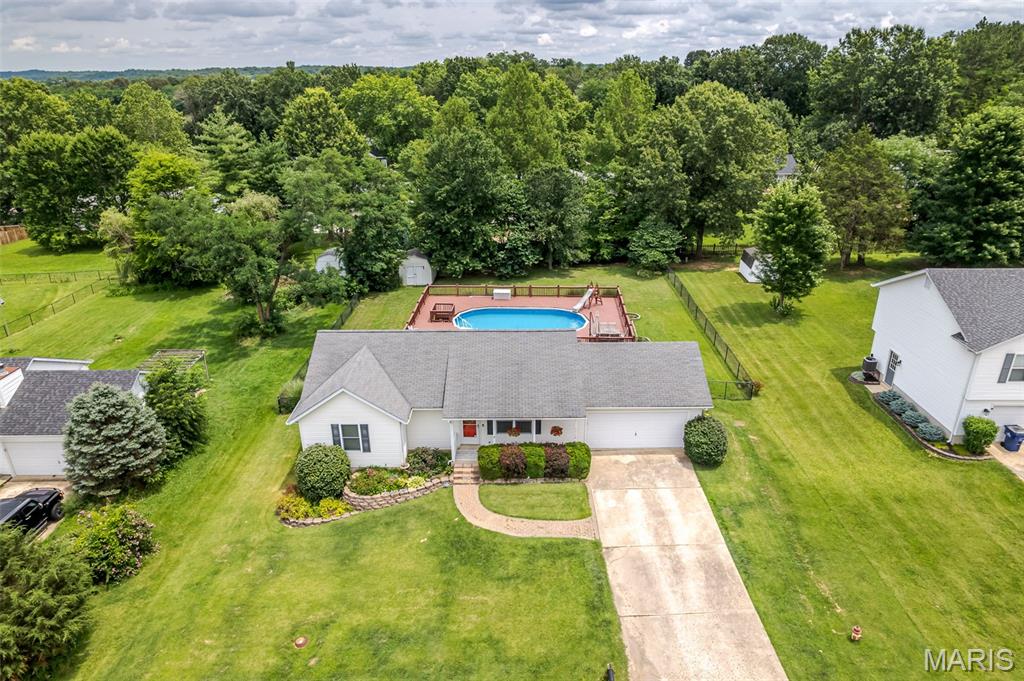 Welcome home to this beautifully maintained ranch in the highly sought-after College Hill Estates! Offering 3 bedrooms, 2.5 baths, and a finished lower level, this home combines comfortable everyday living with plenty of space for entertaining, relaxing, and making memories.

Step inside to find a bright and inviting living room featuring hardwood flooring and a functional layout that flows seamlessly into the kitchen and dining area. The kitchen offers pantry storage and ample workspace, while the spacious primary suite provides a private retreat with its own full bath. Two additional bedrooms and another full bath complete the main level.

Downstairs, the finished lower level expands your living space with a large family room, recreation area, half bath, laundry area, and abundant storage. Whether you need a game room, home office, workout space, or additional gathering area, this flexible space can adapt to your lifestyle.

Step outside and discover your own backyard oasis. The large fenced yard features an above-ground pool, spacious deck, storage shed, and plenty of room for summer barbecues, outdoor entertaining, pets, and play. It's the perfect setting to enjoy warm Missouri evenings with family and friends.

Additional highlights include an attached 2-car garage, public utilities, low-maintenance vinyl siding, and a convenient location within the Union School District. Move-in ready and packed with both indoor and outdoor living space, this home offers the perfect blend of comfort, convenience, and fun.