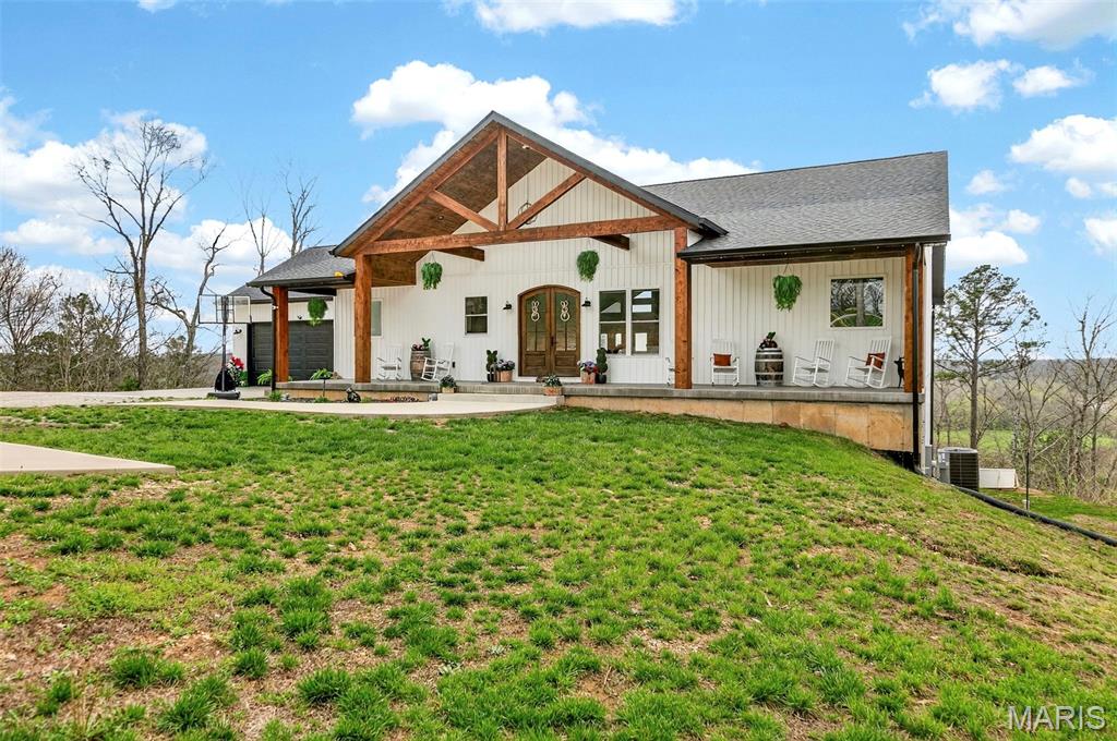 Set on an impressive 10-acre estate along the Meramec River, this exquisite residence offers over 4,400 square feet of thoughtfully designed living space and a rare blend of refined elegance, breathtaking views, and serene countryside living. From its striking curb appeal to the inviting front porch, every detail welcomes you into a home designed for both comfort and sophistication.

Surrounded by natural beauty, the property features its own private nature trails winding through the landscape—perfect for morning walks, peaceful escapes, or exploring your own slice of riverfront paradise. Whether you’re enjoying coffee overlooking the water or unwinding with sunset views across the tree-lined grounds, this setting delivers a truly unmatched sense of tranquility.

Inside, rich hardwood floors and soaring vaulted ceilings define the main level, where an expansive open-concept design creates a seamless flow between the living, dining, and kitchen spaces. The gourmet kitchen is a true showpiece, appointed with quartz countertops, a generous center island with a breakfast bar, premium stainless steel appliances, and abundant custom cabinetry. A spacious walk-in pantry and adjacent laundry room add both convenience and functionality.

The grand living room is anchored by a stunning fireplace with an elegant mantel, flanked by dual sets of sliding glass doors that flood the space with natural light and open to a private balcony—perfectly positioned to capture the stunning views of the surrounding landscape and river below.

The primary suite is a luxurious retreat, featuring a walk-in closet with custom built-ins and a spa-inspired en-suite bath complete with dual vanities, a soaking tub, and a separate shower. A secondary bedroom with a full bath and an additional powder room provide thoughtful accommodations for guests.

The walkout lower level is designed for elevated living and entertaining, offering three additional bedrooms, a full bath, and a spacious family room highlighted by a second fireplace and expansive sliding doors leading to a covered patio that spans the length of the home—seamlessly blending indoor comfort with outdoor beauty.

Additional flexible spaces include a bonus room, storage area, and utility room. A two-car attached garage and ample additional parking complete this exceptional offering—an unparalleled opportunity to enjoy privacy, space, private trails, riverfront access and timeless luxury in one of the area’s most picturesque settings.