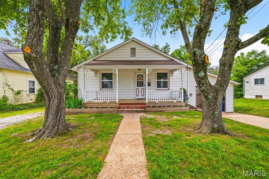 506 E Park Ave offers the kind of setting that is becoming increasingly hard to find — a peaceful, park-like 1-acre property with a small-town feel and everyday convenience. Here you are tucked away on a no-outlet street, minimal traffic.

The scenic backyard backs to Flat Creek, lined by lush natural vegetation, mature trees, and a picturesque ridge line that creates two expansive layers of mostly level yard space. Designed for both relaxation and recreation, the outdoor setting includes a firepit gathering area, including a playset and classic tire swing hanging beneath a mature shade tree overlooking the expansive yard. 

A detached workshop/shed provides additional storage and hobby space, while the oversized one-car carport offers covered parking and strong potential for future garage enclosure.

The Hallmark-like front porch is beautifully framed by two mature trees, perfect for climbing. 

Inside, the home features beautiful hardwood flooring, fresh paint, and a recently updated kitchen with calming deep-green cabinetry, a gas range, brand new fridge, and a sink perfectly positioned to overlook the gorgeous backyard. A charming sunroom provides the perfect space for morning coffee, reading, plants, or additional flex space filled with natural light. 

The walk-up attic offers excellent potential for future finished recreation space, home office, or just extra storage. 

This home is located less than half a mile from Schnucks, and just minutes from local, non-chain restaurants. Nearby, you'll find Union City Park, Veterans Memorial Park, Clark Vitt Park, Hanson Park, and multiple fishing access points including Union Public Fishing Access, Bourbeuse River access areas, and Meramec State Park fishing access providing lots of opportunity for peaceful outdoor activities.

Bonus items: air conditioning replaced May 2026, water heater upgraded to 40 within the last 5 years, all new windows in the last 5 years, Ameren installed new service lines between house and pole in the last few years.