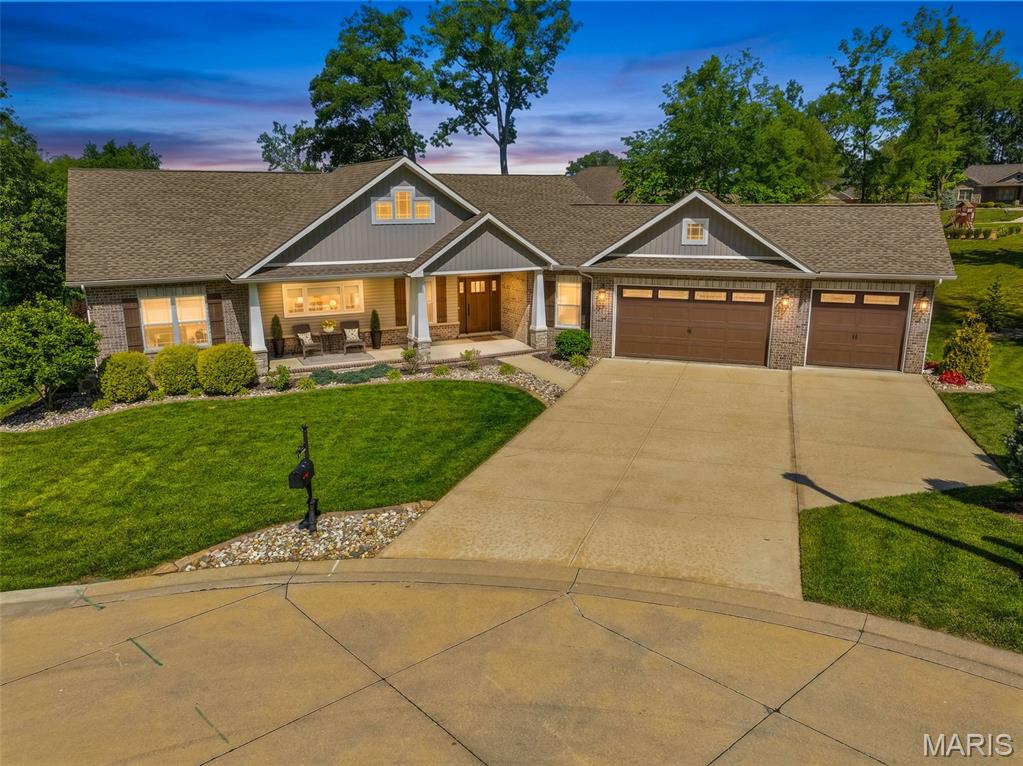 Waterfront living meets everyday luxury at 120 Independence Drive! Nestled on a beautifully landscaped .43-acre lot, this stunning ranch-style home built by Wellen Homes offers the perfect blend of elegance, comfort, and breathtaking natural beauty. With 5 bedrooms, 3 full baths, and an oversized 3-car garage (complete with epoxy floors), there’s room for everyone to spread out and enjoy.  Step onto the inviting covered front porch and into an open-concept floor plan designed for both entertaining and relaxed living. Gorgeous wood floors, soaring natural light, and expansive picture windows frame serene lake views, bringing the outdoors in. The heart of the home is the beautifully appointed kitchen featuring abundant cabinetry, quartz countertops, stainless steel appliances, subway tile backsplash, and an oversized island perfect for gathering. The thoughtfully designed split-bedroom floor plan offers privacy, with a luxurious primary suite showcasing peaceful water views, a spacious L-shaped walk-in closet, soaking tub, separate shower, and convenient access to the generous main-floor laundry room. Three bedrooms are located on the main level, while the partially finished walk-out lower level offers 2 additional bedrooms, a full bath, wet bar, abundant storage, and flexible living space for guests, hobbies, or entertaining. Out back, your private retreat awaits! Relax on the covered composite deck as wildlife wanders by, enjoy spectacular sunset reflections dancing across the lake, or simply soak in the peaceful waterfront setting. Additional highlights include a new roof (2025), underground pet fence, and impeccable curb appeal at the back of a cul-de-sac. Offering the perfect balance of serene lakefront living and convenient access to Highland’s parks, shops, restaurants, and commuter routes. This is more than a home—it’s a lifestyle.