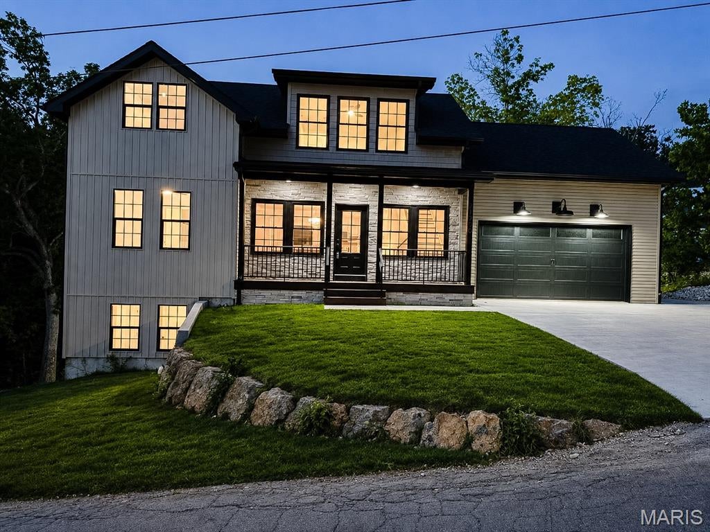 MOVE IN READY.  Step into this stunning brand-new 5-bedroom, 3.5-bath home where modern design, comfortable living, and incredible outdoor space come together beautifully. Set on a spacious lot surrounded by mature trees, this home offers a peaceful setting while delivering the style and features buyers are looking for.

Inside, the open-concept main level is filled with natural light and features a gorgeous kitchen with granite countertops, large center island, pantry, abundant cabinetry, and modern finishes throughout. The main-level primary suite offers convenience and privacy, along with main-level laundry and plenty of room for everyday living and entertaining.

The finished basement adds even more usable space with endless possibilities for a second living area, game room, home office, guest space, or growing family. With five bedrooms and three-and-a-half baths, there is room for everyone without sacrificing the open feel of the home.

Outside may be just as impressive. Enjoy the AI-rendered sod concept showing the potential finished lawn, large deck overlooking the wooded surroundings, covered front porch, oversized concrete driveway, and attached garage. The combination of modern construction and a beautiful natural setting makes this property truly special.

Brand new, beautifully finished, and ready for its first owner—this is one you’ll want to see in person.