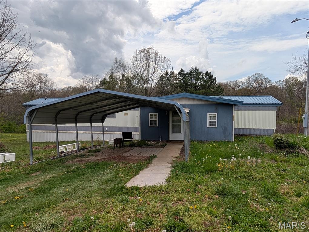 Charming 1995 single-wide mobile home with addition, offering comfortable living on 5.3 peaceful acres. This home features updated kitchen cabinetry, a spacious living room, and a screened-in back porch. The property also includes a tornado shelter for added safety and peace of mind. A great opportunity for country living with room to spread out!