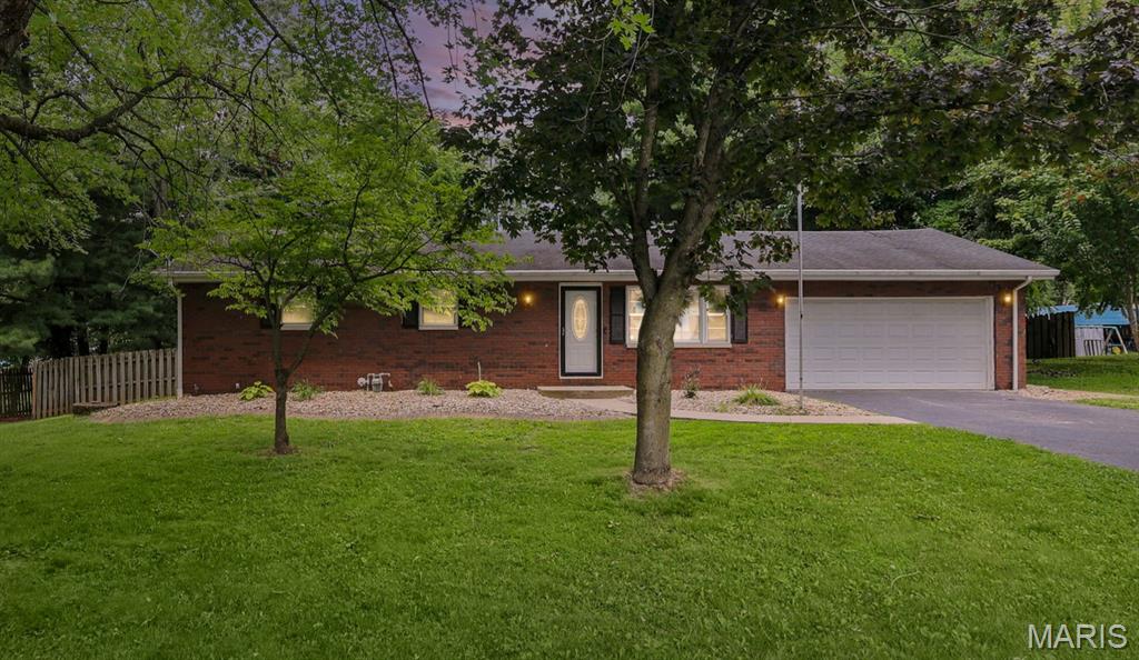 Beautifully maintained and thoughtfully updated, this all-brick ranch offers the perfect blend of quality construction, modern comfort, and a peaceful setting in the highly sought-after Triad School District. Featuring 3 bedrooms, 2 full baths, and a convenient main-floor laundry room, this move-in-ready home is ready for its next owner.

Freshly updated with new interior paint, drywall touch-ups, new carpet in all three bedrooms, updated lighting and electrical finishes, new door hardware, and a freshly painted garage, the home offers a clean, modern feel from the moment you step inside.

Natural light fills the inviting interior, creating warm and comfortable living spaces throughout. The showpiece of the home is the stunning all-season room, featuring a beautiful plank ceiling and panoramic views of the backyard. Whether you're enjoying your morning coffee, entertaining guests, or simply unwinding at the end of the day, this space is one you'll enjoy in every season.

Situated on a spacious .49-acre lot, the fenced backyard is surrounded by mature trees, offering a peaceful, park-like setting with plenty of room to relax, entertain, garden, or simply enjoy the outdoors.

The unfinished walkout basement provides outstanding potential for future expansion. Already equipped with a rough-in for a future full bath and protected by a professionally waterproofed basement system installed in 2017, it's the perfect blank canvas to create additional living space tailored to your needs.

Offering timeless all-brick construction, modern updates, room to grow, exceptional outdoor space, and an outstanding location in the Triad School District, this is a home you'll be proud to call your own.