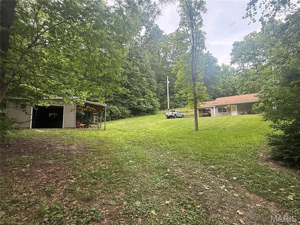 Wooded acreage with hunting cabin and detached garage. Lots of recreational opportunities, well established trail system, several hunting blinds and stands. This is a great deer and turkey area. The cabin features an attached garage, two bedrooms, one bathroom with city water and electric connected. Also detached garage with a deer cooler, electric connected and a lean to.