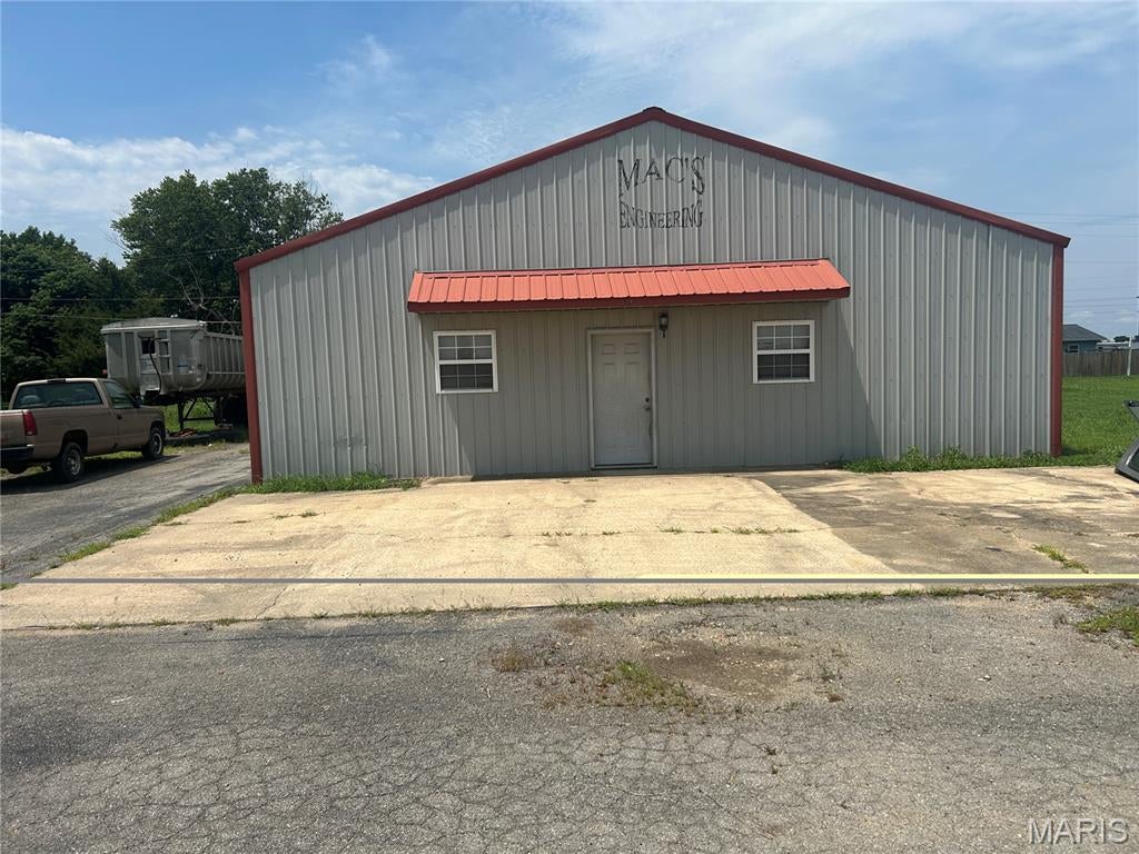 DO NOT miss out on this OPPURTUNITY!
If you are looking for a shop building for your business or simply need a great place to store your stuff!  This place has a lot to offer.  This metal shop building sits on a very nice-sized lot zoned R-2 which can be used as a shop or home.  There is an asphalt/concrete parking area in the front and on the side.  In addition to this, there is a two-acre adjoining lot that is zoned residential that is ready for your vision!  Inside you will find living quarters that features a full kitchen with appliances.  You will also find a full bathroom and two separate rooms which can be utilized as your office space or a place to unwind and relax.  The spacious shop area features an overhead door to the side with plenty of lighting.  This facility was once used as a machine shop and has the electrical capacities for most any type of industrial use.  Call an agent today to schedule a tour of this property.