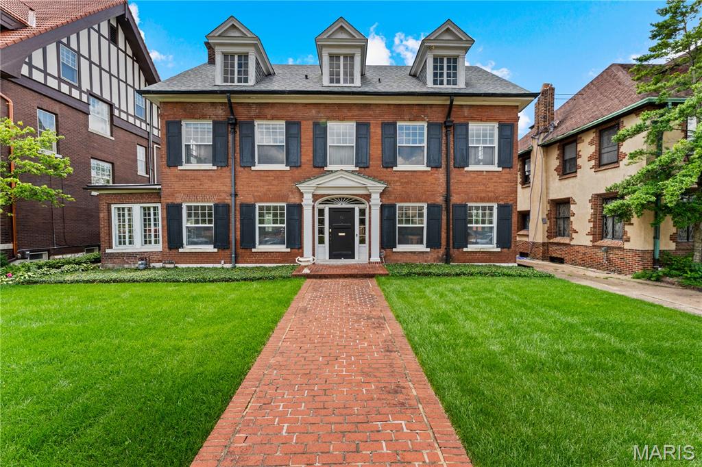 Magnificent Georgian Colonial in the heart of Kingsbury Place. A charming vestibule welcomes you into a gracious central hall floor plan, where a sweeping grand staircase ascends to a dramatic landing, illuminated by a stunning window with views of the patio and deep backyard. Rich architectural details, including 9-foot ceilings, original millwork, elegant crown molding, and beautiful hardwood floors—all showcasing the home's timeless character. The spacious living room boasts a marble fireplace, abundant natural light, and French doors that open to the patio, offering a seamless flow for indoor-outdoor living. An enclosed side porch offers additional space to relax and unwind. The eat-in kitchen features custom cabinetry, granite countertops, a Viking range, a Sub-Zero refrigerator, a Bosch dishwasher, a butler’s pantry, and a walk-in pantry, providing the perfect foundation for your future dream kitchen. Upstairs, the second-floor hosts four bedrooms and two full baths with original tile, while the third floor offers a large recreation room, two additional bedrooms, and a full bath. A brand-new roof, detached two-car garage, and expansive, level backyard completes this property. Ideally situated near Forest Park, Barnes-Jewish Hospital, and the vibrant restaurants, shops, and entertainment of the Central West End.