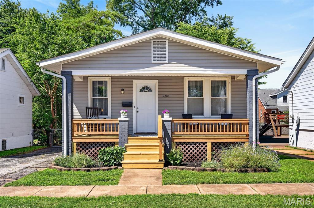 Charming and well maintained 2-bedroom home in South St. Louis City.  Step up onto the delightful front covered porch with all new handrails and decking. Enter and relax in the main living area with lovely natural light, beautiful stained-glass window, hardwood floors, electric fireplace and designated dining.  Kitchen boasts a stainless gas range, ample cabinetry, breakfast bar that adds extra counter space and tile flooring.  Off the kitchen, enjoy morning coffee on the newly built back deck looking over the backyard. Primary bedroom has hardwoods floors and ceiling fan. Second bedroom or possible home office has hardwood floors and built in shelving.  Bathroom features tub/shower combo with classic city glass block, tile floor, and updated vanity.  Basement has plenty of space to be transformed into additional entertaining or gaming area and has roughed-in and usable toilet and sink.  Additional basement area for laundry and storage.  Uniquely, this home has a one- car detached garage and three off-street parking spaces.  Add nearby shopping, parks and restaurants and this all adds up to a great find.