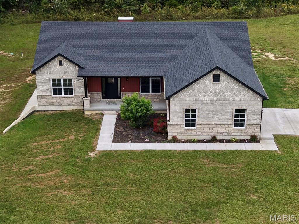 Welcome to your new home in the heart of Missouri wine country, where scenic countryside and modern living come together on 3.24 beautiful acres. This brand-new construction offers the space, privacy, and thoughtful design you've been waiting for, all just minutes from Farmington.

Step inside to an inviting open-concept living area featuring vaulted ceilings, a striking fireplace, modern fixtures, and carefully selected finishes throughout. The split-bedroom floor plan provides privacy and functionality, with a spacious primary suite designed to be your personal retreat. Enjoy a luxurious soaking tub and generous walk-in closet.

The walk-out basement is partially finished and offers versatile space ready to accommodate your needs, whether you're looking for a recreation room, home office, workshop, or additional living area. Outside, the corner lot backs to the woods, creating a peaceful setting with abundant privacy and plenty of room to enjoy the outdoors.

Craftsman-inspired masonry work and quality details add character and distinction throughout the home. A convenient 2-car garage provides ample parking and storage. With acreage, wooded views, new construction, and a desirable location near Farmington, this property offers a rare opportunity to enjoy the best of country living without giving up modern convenience.

Come make this beautiful new house your home and experience the space, privacy, and serenity of Missouri countryside living.