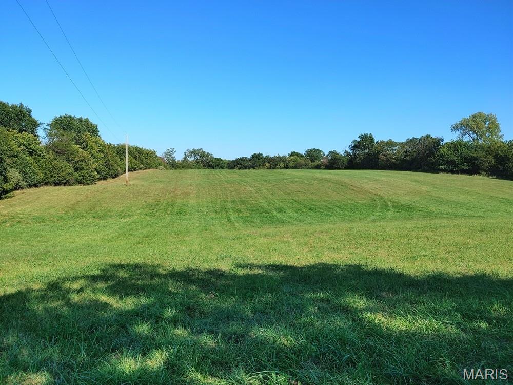 Discover the perfect setting to build your dream home on this stunning 16.82-acre property featuring multiple ideal building sites and breathtaking views of beautiful rolling pastures. Approximately 10 acres are open pasture, with an additional 6 acres of wooded ground filled with mature trees, offering a great balance of open space and privacy. The property is fenced, making it ideal for livestock or recreational use. Conveniently located near Highway 24, this property offers the perfect combination of peaceful country living with easy access to nearby amenities and commuting routes. A scenic pond adds to the charm and natural beauty, creating a picturesque backdrop for your future home. Also included is an 18x26 metal building with a convenient roll-up door, perfect for equipment storage, a workshop, or hobby space. With serene surroundings and endless possibilities, this exceptional property is a rare opportunity to create the lifestyle you’ve been dreaming of. Contact your favorite agent today!!!