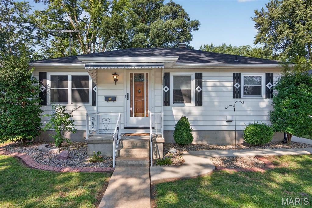 ADORABLE 2 bedroom home w/hardwood floors in Living rm, Primary bedroom & bedroom #2. 20 X 21 detached garage w/door opener, 14 X 17 covered patio w/storage closets. Gorgeous kitchen w/cherry wood cabinets, corian countertops and appliances. LL features large open family room/rec room, kitchen, other built-in cabinets, shower, lots of storage. House & garage roof 2022. Double hung windows replaced 2022. Leaf filter gutter guards on house 2023. HWH 2022. New lateral sewer line 2019. Beautiful backyard.  Nicely landscaped.