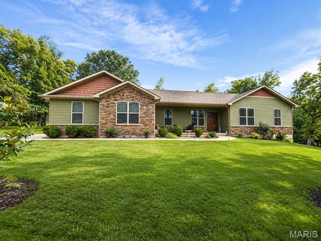 Dreaming of the ultimate lake lifestyle? Welcome to Summer Set — one of De Soto, Missouri’s most sought-after private lake communities, where every day feels like a getaway. Residents enjoy access to 3 private lakes, 2 gated entrances with security, beach and picnic areas, boat dock, and community events, including fishing tournaments and an unforgettable fireworks celebration. From summer days on the water to fall Trunk-or-Treat fun, this is more than a neighborhood — it’s a lifestyle.

Built just 5 years ago, this beautiful 3-bedroom, 2-bath home still feels practically brand new. Step through the front door into a spacious open floor plan designed for both comfort and entertaining. The inviting living room flows seamlessly into the stunning kitchen featuring a large center island, granite countertops, stainless steel appliances, and easy-to-maintain hard surface flooring throughout. A generous dining area leads directly out to the oversized covered patio — the perfect spot for BBQs, relaxing evenings, and gathering with friends and family.

The sale includes a second lot, giving you an impressive 0.85 acres and an expansive backyard with room to spread out and enjoy. Inside, the thoughtfully designed mudroom/laundry area connects to the oversized 3-car garage, offering plenty of space for vehicles, boats, golf carts, and lake toys — plus an oversized driveway for even more parking.

The bedrooms provide comfort for everyone, while the primary suite offers a true retreat with a walk-in closet, double vanity, and tiled walk-in shower complete with a waterfall showerhead. Downstairs, the full walkout basement with a bathroom rough-in offers endless potential for additional living space, a recreation area, home gym, or whatever fits your vision.

If you’ve been waiting for a move-in ready home that combines modern finishes, extra space, and an incredible lake community lifestyle — this is it.