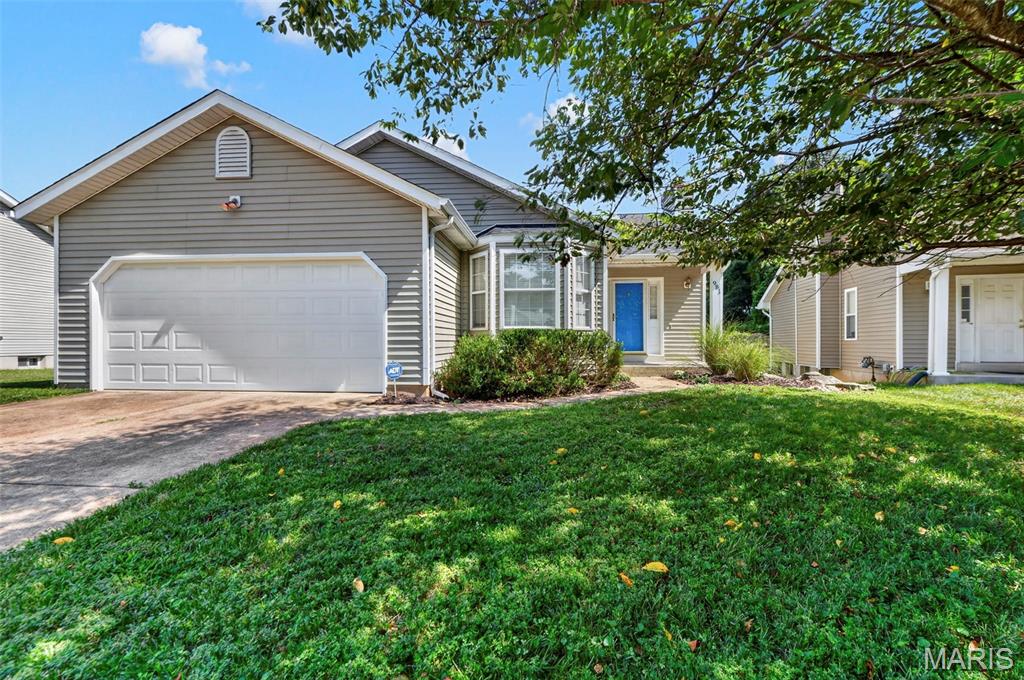 Welcome to this beautifully maintained 3-bedroom, 3-bath home offering a warm and inviting blend of comfort, space, and style. The open floor plan is enhanced by beautiful hardwood floors, soaring vaulted ceilings, and an abundance of natural light, creating a bright and spacious atmosphere throughout the main living areas. The inviting living room features a cozy fireplace, perfect for relaxing on cool evenings, while the adjoining dining room offers sliding doors with picturesque views of the tree-lined backyard.

The well-appointed kitchen provides plenty of cabinetry and generous counter space, along with a convenient breakfast bar that opens to the main living area. The spacious primary suite offers a peaceful retreat with a charming bay window, walk-in closet, and private en-suite bath. Two additional bedrooms and a full bath complete the main level.

The expansive lower level provides even more living space with a large recreation room and full bath—perfect for entertaining, a media room, guests, or additional family living. Step outside to enjoy the large deck overlooking the beautiful backyard, with a patio below creating the perfect setting for summer BBQs, gatherings, or simply relaxing outdoors. The generous green space offers plenty of room for gardening, play, and recreation. Conveniently located near Hwy 141 with easy access to shopping, dining, parks, and everyday amenities, this home offers the space and location you've been looking for!