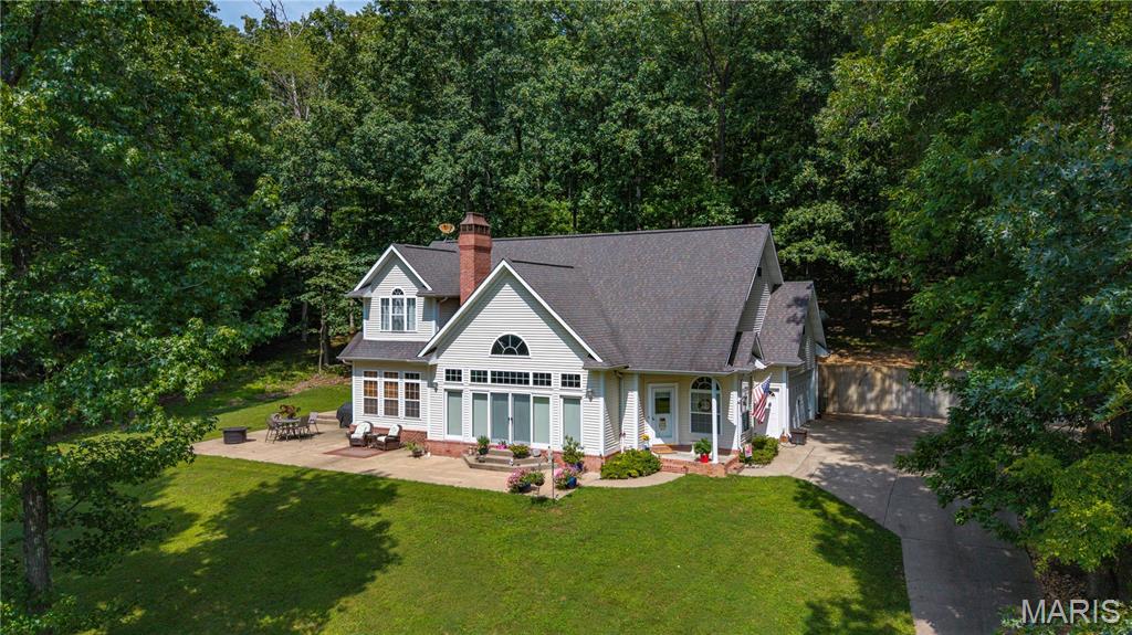 Private 5.8-Acre Retreat with Barn & Room to Roam! This spacious two-story home offers privacy, charm, and plenty of functional living space. Vaulted ceilings create an open, inviting feel in the main living areas, featuring a cozy fireplace and beautiful wood floors. The open kitchen is designed for gathering with granite countertops and a convenient bar-top overlooking the living space. The main-level primary suite includes a large walk-in closet with convenient access to the main-level laundry. Three additional bedrooms are located upstairs, along with a large attic storage area and laundry hookups for added flexibility. Enjoy the peaceful, private setting with a barn and abundant acreage for outdoor activities, hobbies, or animals. Potential 2nd home living space add even more versatility. A rare opportunity to enjoy space, privacy, and convenience all in one property!