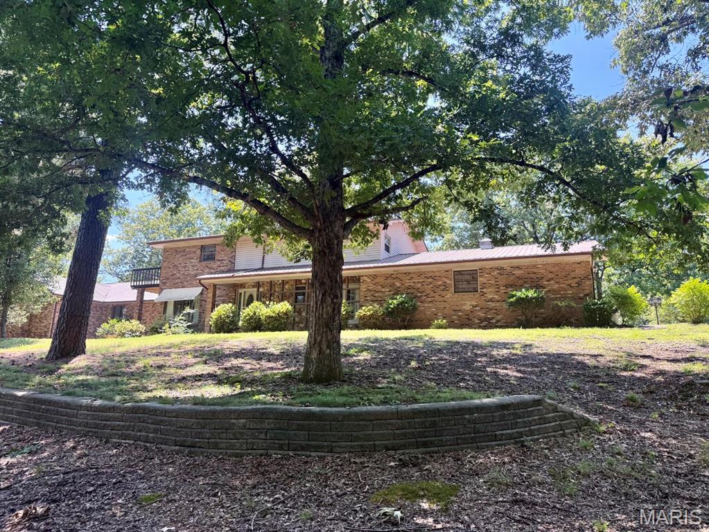 If you’ve been searching for room to spread out, this incredible home offers over 4,900 square feet of living space on a 1.619-acre wooded lot in a quiet residential setting.  This home features 4 bedrooms with the potential for a 5th bedroom in the basement, 4 full bathrooms, and 2 half baths.  The home offers two primary suites, making it ideal for multi-generational living or guests. The main-level primary suite boasts an impressive 15’ x 8’ walk-in closet complete with built-in organizers. You’ll also appreciate the convenience of two laundry rooms—one on the main level and one in the basement.  Comfort is ensured year-round with three HVAC units, while two fireplaces create warm and inviting gathering spaces. A 20kW whole-house generator, fueled by an owned propane tank, provides added peace of mind during power outages.  Accessibility features include chair lifts on both staircases, making movement between levels easier. Outside, you’ll find a storage shed, 3 car garage and a  private, wooded setting that offers both beauty and tranquility. (The carport does not convey with the property.)