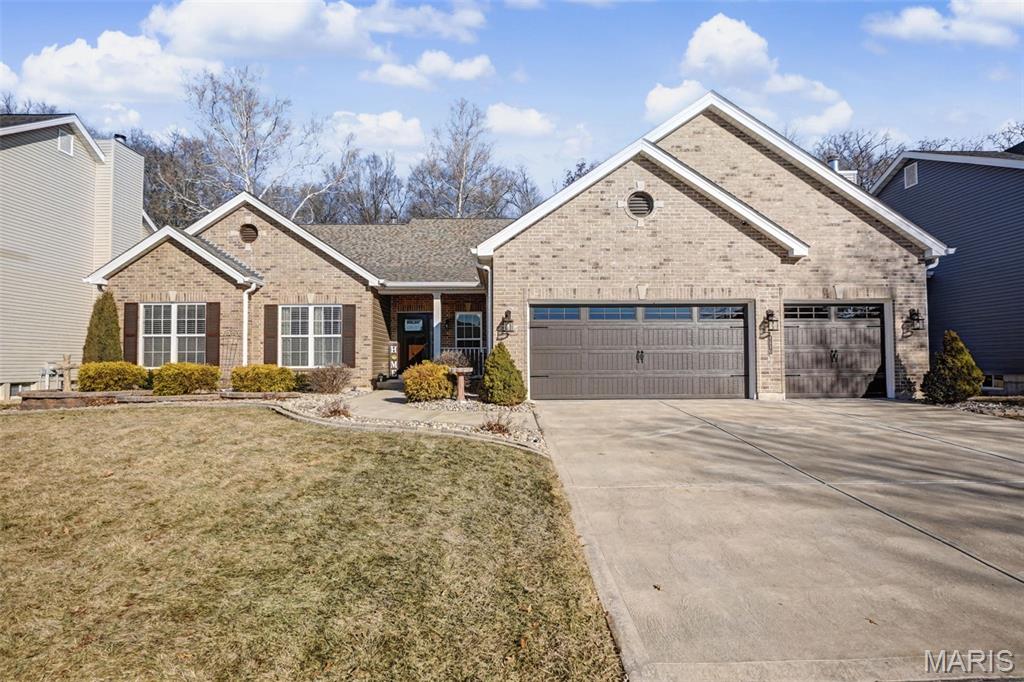 One of the very few ranch homes in the subdivision, this thoughtfully designed residence offers 2426 square feet of main-level living with an open floor plan ideal for both everyday comfort and entertaining.  The home features three bedrooms, three and a half baths, and a dedicated office.  Nine-foot ceilings run throughout the main level, highlighted by a dramatic 12-foot ceiling in the great room with a striking floor-to-ceiling brick fireplace as the focal point. The kitchen opens seamlessly to the living and dining areas and provides walk-out access to a partially covered patio overlooking a private, wooded backyard-perfect for relaxing or hosting guests in a peaceful setting. The finished lower level adds approximately 1,200 square feet of additional living space, including a large recreation area with ample room for games, gatherings and entertaining around the wet bar. 
Additional features include a Lorex security system with exterior cameras, offering added peace of mind.  Major updates include a new hail-resistant roof, 6" gutters, and siding installed in 2024, along with a new insulated garage door and front door installed in 2020.
A rare ranch opportunity combining quality construction, important updates and a private wooded setting all near St. Dominic high school or Fort Zumwalt schools and O'Fallon restaurants and shopping.