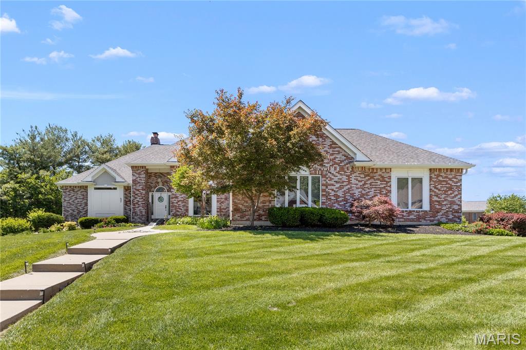 An extraordinary opportunity to own a fully reimagined custom atrium ranch with breathtaking views of Lake St. Louis in the highly sought-after Moorings subdivision. Perfectly positioned to capture picturesque water views, this exceptional residence blends timeless architecture with sophisticated updates and access to the unparalleled lifestyle and amenities offered through Lake St. Louis Community Association.

Designed to maximize natural light and showcase the stunning backdrop, the atrium-style floor plan creates a seamless connection between indoor and outdoor living. Expansive windows overlook the beautifully landscaped grounds, sparkling saltwater pool with newer liner, heater, and filter, covered patio, sprinkler system and spacious composite deck—creating the ideal setting for entertaining or simply enjoying the serene lake views.

At the heart of the home is a stunning designer kitchen featuring premium Cafe appliances, including double ovens with air fryer functionality, warming drawer, built-in microwave, dishwasher, pot filler, and custom finishes that elevate both form and function. New luxury plank flooring extends throughout the main level, complemented by a striking stone fireplace with new gas insert and custom mantel.

The luxurious primary suite offers a true spa-like retreat with an expansive walk-in shower, vessel soaking tub, and dual vanity. A rare feature, the main level includes two private owner’s suites, providing exceptional flexibility for multi-generational living, guests, or accessibility needs, with the secondary suite offering handicap-accessible features. Every bathroom, along with the laundry and powder rooms, has been thoughtfully renovated with quality craftsmanship and designer selections.

The finished walkout lower level expands the living experience with a spacious recreation room, second gas fireplace, bar area, two additional bedrooms, updated full bath, and a dedicated fitness room designed for today’s wellness-focused lifestyle.

Significant recent improvements include a newer roof and gutters ('23), two new HVAC systems, new water heater, updated pool equipment, and extensive interior renovations, offering the next owner the rare benefit of a truly turnkey luxury home.

An oversized garage provides exceptional space for multiple vehicles, a boat, RV, workshop, or hobby storage—an uncommon feature in this price point. 

Residents enjoy access to the exceptional amenities of Lake St. Louis Community Association, including two lakes, marinas, championship golf courses, swimming pools, tennis and pickleball courts, parks, trails, and year-round community events.

This is luxury lake-view living at its finest—where timeless design, modern updates, resort-style outdoor living, and an unmatched lifestyle come together in one exceptional property.