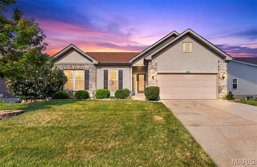 This beautifully updated 3-bedroom, 2-bath ranch offers an inviting open-concept layout perfect for modern living. Enjoy peace of mind with a new roof, new siding, and new gutters, plus a stylish kitchen boasting 42” cabinets and a custom backsplash.  The kitchen also features stainless steel appliances—with the refrigerator, washer, and dryer all staying with the home. The living room showcases an elegant wood-burning fireplace and hardwood flooring that flows throughout the main living area. The home also offers 9ft. ceilings on the main floor.  The spacious primary suite includes an ensuite with a walk-in shower, dual-bowl vanity, and a generous walk-in closet. Two additional bedrooms complete the main floor.  The look-out lower level is ready for your personal design and expansion. Step outside to a private, tree-lined backyard offering a serene retreat. Spacious deck to relax and enjoy your outdoor space.   Located in the highly sought-after Wentzville School District and close to shopping, dining, and everyday conveniences, this home delivers comfort, updates, and an ideal location. This could be your new home!  Say “Yes” to the address!  1125 Crystal Creek Parkway, Wentzville, MO  63385.