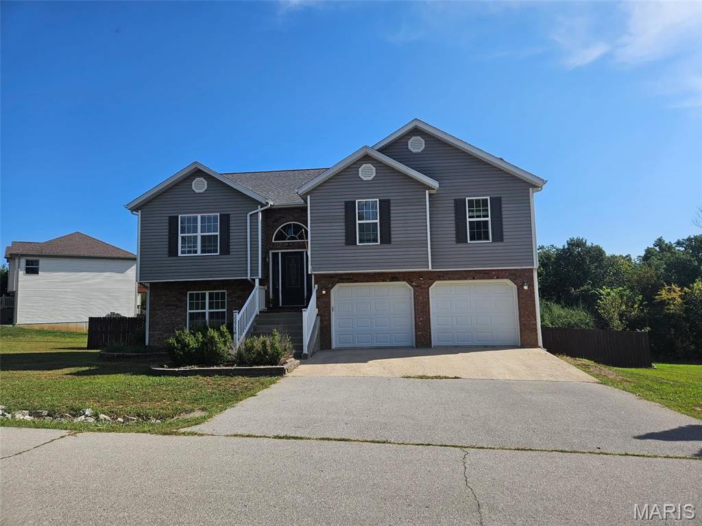 Situated on a corner lot, this spacious 4-bedroom, 3-bath split-foyer home offers a functional layout with room for everyone. The upper level welcomes you with vaulted ceilings, hard-surface flooring in the main living space, and a spacious living room that flows into the kitchen and dining area. The kitchen features stainless steel appliances, convenient counter seating, and access to the back deck, perfect for everyday living or entertaining.

The primary suite is carpeted for comfort and offers a private retreat with a recessed ceiling, large walk-in closet, and private bath complete with dual sinks, a separate jetted tub, and stand-up shower. The lower level provides even more living space with a comfortable family room, along with an additional bedroom and full bath. A large garage adds plenty of room for vehicles, storage, or hobbies. With its generous living space, desirable corner lot, and versatile floor plan, this home is ready to welcome its next owner.