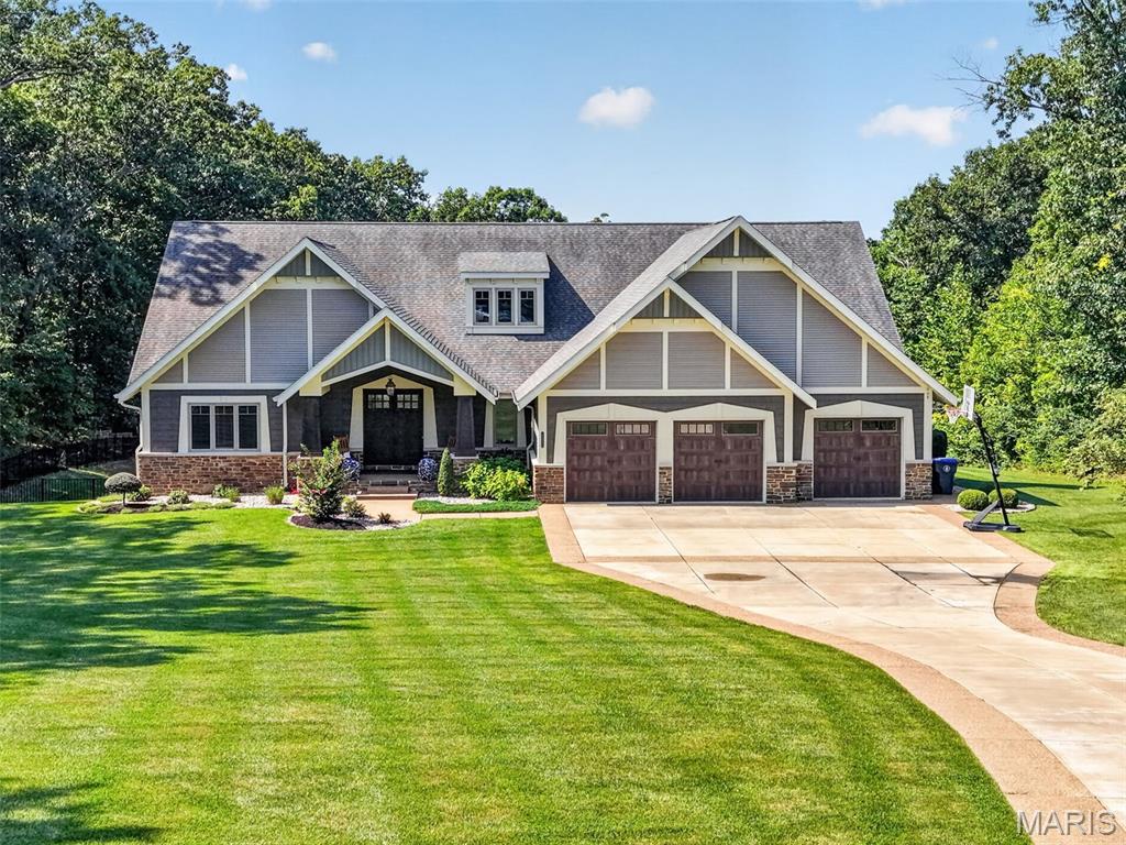 Set behind a private tree-lined setting on more than 5 acres, this exceptional custom-built ranch offers a rare combination of refined craftsmanship, expansive living spaces, and resort-style outdoor living. Thoughtfully designed with an unmistakable attention to detail, the home welcomes you with 12' ceilings, 8' interior doors, striking light fixtures, coffered and wood-beamed ceilings, and an abundance of natural light throughout.
The heart of the home is a true chef’s kitchen, beautifully appointed with granite countertops, an oversized center island with breakfast bar and farmhouse sink, professional-style gas range with multiple burners, heavy-duty cast-iron grates, integrated griddle and pot filler, and a dramatic stone surround with stainless steel hood. A sleek oversized French-door refrigerator, built-in microwave, and large walk-in pantry with extensive shelving add both style and function. The kitchen opens seamlessly to a charming breakfast nook and inviting hearth room, where a floor-to-ceiling stone fireplace creates a warm gathering space surrounded by windows on multiple sides.
Just off the entry, the elegant living room makes a statement with a gorgeous chandelier, accent ceiling details, and French doors leading to the covered back deck, complete with an outdoor fireplace—creating an effortless extension of the living space. The main-level primary suite is privately positioned behind French doors and offers a spa-inspired retreat with dual sinks with granite counters, a large jetted tub, and an impressive 6' x 6' tiled shower with bench seating and three shower heads, including a waterfall feature. The spacious walk-in closet connects directly to the laundry room, which is also accessible from the main hallway.
Three additional main-level bedrooms each feature generous walk-in closets and private en suite baths, offering exceptional comfort and privacy for family and guests. A dedicated home office, powder room, and thoughtfully designed mudroom/drop zone with cubby-style storage complete the main level.
The finished walkout lower level expands the home’s living and entertaining possibilities with a fifth bedroom featuring its own private flex area, walk-in closet, and en suite bath. A spacious recreation room spans much of the lower level and includes a beautifully finished bar and kitchen with quartz countertops, refrigerator, dishwasher, microwave, and beverage cooler. A separate flex space behind French doors offers endless possibilities for a home office, fitness room, craft space, gaming area, or additional lounge. A second half bath adds convenience, while abundant lookout windows and walkout access bring natural light into the lower level.
Outside, the setting is nothing short of spectacular. Surrounded by mature trees for exceptional privacy, the expansive backyard is designed for both relaxation and entertaining with a large saltwater pool, dedicated fire pit area, fenced yard, irrigation system, and plenty of room to gather, dine, and enjoy the outdoors. An oversized three-car garage provides ample space for vehicles, storage, and everyday living.
A truly special property where sophisticated design, thoughtful functionality, and an extraordinary private setting come together—offering the space, craftsmanship, and lifestyle rarely found in one remarkable home.