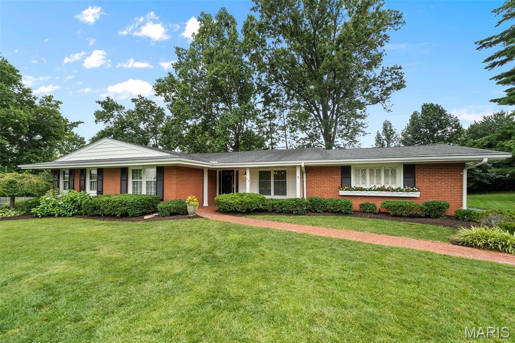 Welcome home to a place where timeless charm, exceptional care, and the warmth of a true neighborhood come together. Nestled on a quiet and quaint cul-de-sac in the heart of highly desirable Warson Woods, this beautifully maintained ranch offers the perfect blend of comfortable one-level living, inviting spaces for gathering, and the kind of community where neighbors become friends and lasting memories are made. From the moment you arrive, you will fall in love with the home's wonderful curb appeal, covered front porch, lush landscaping, and welcoming presence. Once inside, you will be greeted by a lovely foyer flanked by the dining room and spacious living room featuring beautiful windows, gleaming hardwood floors, and abundant natural light. The heart of the home offers a warm and inviting family room with a fireplace and a planning desk—perfect for homework, household organization, or workspace. The family room flows seamlessly into the breakfast area, where a charming bay window provides the perfect spot for a kitchen table and fills the space with natural light. The attractive kitchen showcases white cabinetry, a center island, and a neutral palette. Conveniently located adjacent to the dining room and open to the family room, the layout is ideal for both everyday living and entertaining.  The main level also offers three bedrooms, a hallway full bath, a comfortable primary suite featuring sunlit windows, ample closet space, and a private en-suite bath. The finished lower level provides exceptional flexible space with a large TV or recreation area, home office, home gym, sleeping area, a convenient half bath, and abundant storage.  Step outside from the family room through the sliding glass doors to the brick patio—an inviting setting for morning coffee, outdoor dining, or relaxing with family and friends. An attached two-car garage completes this exceptional home.  You'll also fall in love with the neighborhood lifestyle, where children ride bikes, neighbors wave hello, and evening walks with the dog are part of everyday life. This is more than just a home, it is a place to put down roots, create lasting memories, and enjoy everything that makes Warson Woods such a special community.