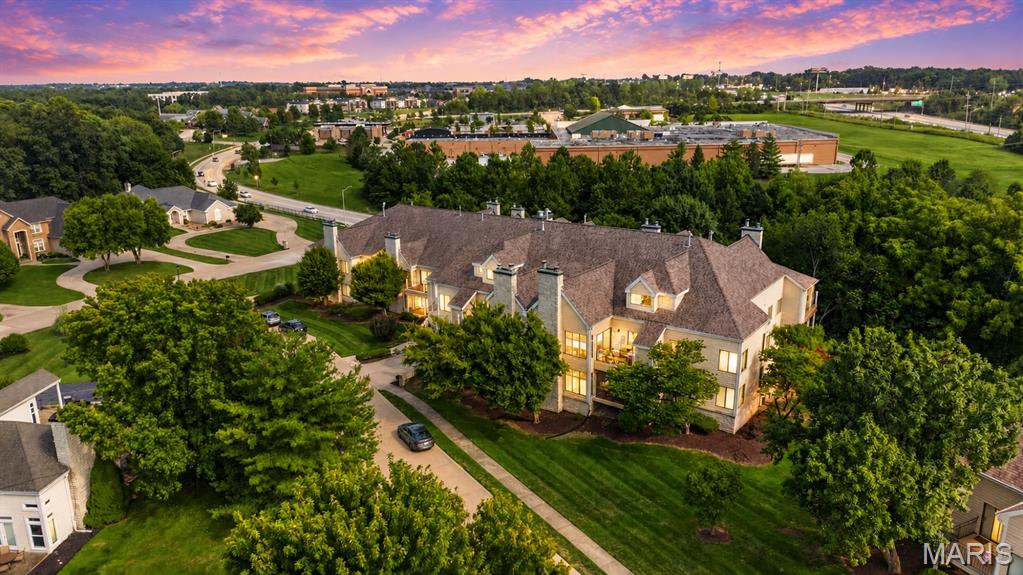 Welcome to a rare opportunity to enjoy spacious, updated living paired with the incredible lifestyle and amenities of Lake St. Louis! Offering approximately 1,665 sq. ft. of thoughtfully designed living space, this beautiful 2-bedroom, 2-full-bath home combines comfort, style and convenience with a peaceful setting that provides a wonderful sense of privacy. From the moment you step inside, you'll appreciate the inviting floor plan, premium updated flooring throughout and abundant natural light.  At the heart of the home is the completely updated kitchen, featuring beautiful marble countertops, new stainless steel appliances, generous cabinet and counter space, and a clean, modern design. The kitchen opens toward the dining room, creating an easy flow for everyday living and entertaining. Just beyond the dining area, sliding glass doors lead to the walk-out deck, an ideal extension of the living space for enjoying your morning coffee, dining outdoors, unwinding in the evening or simply taking in the home's quiet and peaceful surroundings.  A few steps down, the elegant sunken living room gives the home a distinctive architectural touch and creates a warm, comfortable gathering space. Anchored by a gas fireplace, this inviting room offers plenty of space to relax, entertain guests or settle in for a cozy evening at home.  The spacious primary bedroom feels like its own private retreat, complete with a walk-in closet and French doors leading into the ensuite full bathroom. Inside, double vanity sinks provide plenty of personal space and functionality while adding to the comfortable feel of the primary suite. A generously sized second bedroom offers flexibility for family, overnight guests or a home office and is conveniently complemented by a second full bathroom.  The home also features a large dedicated laundry room with electric hookups, providing valuable additional space for everyday household needs. Storage and parking are equally impressive, with easyelevator access to two assigned parking spaces in the secure climate-controlled parking garage, providing convenient protected parking, along with additional private storage for seasonal items, recreational gear and everything you don't want taking up valuable space inside the home.  What truly sets this property apart, however, is the lifestyle that comes with living in Lake St. Louis. Residents have access to the area's wonderful community amenities, with the option to enjoy coveted Lake St. Louis lake rights for $650/year. Whether you envision spending your free time on the water, enjoying the surrounding community or simply taking advantage of everything Lake St. Louis has to offer, this is a lifestyle that extends well beyond the walls of the home. And it's pet friendly!  Despite being close to so much, the unit itself maintains a wonderful sense of privacy. Quiet, peaceful and tucked away from the hustle and bustle, it's especially well suited for someone who appreciates having a relaxing place to come home to at the end of the day. With approximately 1,665 sq. ft., 2 bedrooms, 2 full baths, a primary ensuite with French doors, double vanities and walk-in closet, updated kitchen with marble countertops and new stainless steel appliances, premium flooring, gas fireplace, sliding glass doors, walk-out deck, large laundry room, two assigned spaces in a secure climate-controlled parking garage, additional storage, optional Lake St. Louis lake rights and a pet-friendly community, this home delivers an exceptional combination of space, updates, convenience and lifestyle. Move right in and start enjoying everything Lake St. Louis living has to offer! Schedule your showing today, motivated seller! Seller's offering a base condo home warranty.
