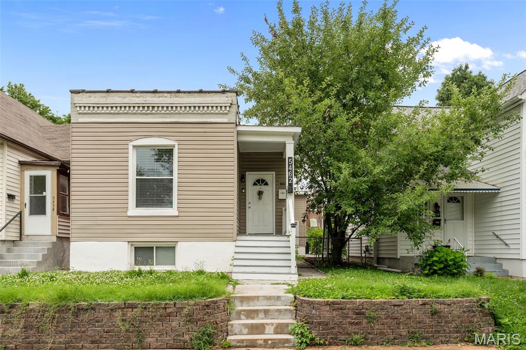 Look no further than this charming bungalow in St. Louis's Bevo Mill neighborhood! You'll be right across from the green space surrounding Christy Boulevard, and steps from Joseph R. Leisure Park, plus all of the shops, restaurants, and nightlife in Bevo. Dentil molding detail and a covered front porch welcome you inside. The foyer opens to the bright living room with a beamed ceiling, archway, and gleaming hardwoods that continue down the hall into all three bedrooms. The primary bedroom can also function as a den or living room, with a floor-to-ceiling brick-surround gas fireplace. The spacious eat-in kitchen features tile flooring and backsplash, and a large pantry. Two more bedrooms with recessed lighting and wood floors, and a full bathroom with a tile-surround tub completes the main level. The basement adds a finished sleeping area/office, plus unfinished storage space. You'll have even more room for storage in the backyard shed. Enjoy gathering with friends under the pergola in the fenced backyard. You'll have alley-access off-street parking as well. With quick access to schools, highways, and all that the South City area has to offer, this home is one you won't want to miss!