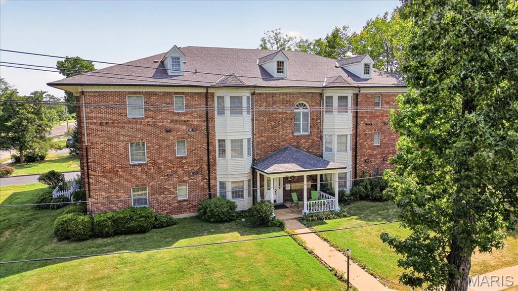 Location, location!  Well built, 4 sides brick handsome 3 story building within easy walk to downtown Kirkwood!  Features of unit 336 include two spacious bedrooms and two full bathrooms in this top (third) floor condo with convenient access to large ELEVATOR.  New carpet, freshly painted walls, new electric panel, window blinds.  Linen closet, coat closet and mechanical closet.  One level living with in-unit laundry. Primary bedroom has windows on two elevations, two good size organized closets, ceiling fan, and ensuite bathroom. Second bedroom also has an organized closet, a nice window, and ceiling fan. Hall bathroom is a full bath with tub/shower combination.  Lovely living room with bay window and built-in bookcase.  Dining area looks into the kitchen through the breakfast bar.  So many cabinets in the kitchen!  Vented microwave over stove.  HVAC 2019.  New roof installed 2023.  New elevator mechanics installed 2025.  This condo is in very good condition and shows well.  One attached carport space provides covered entry into the building. This quiet 10 unit condo community will welcome you.  Refrigerator included at no cost, but not warranted.