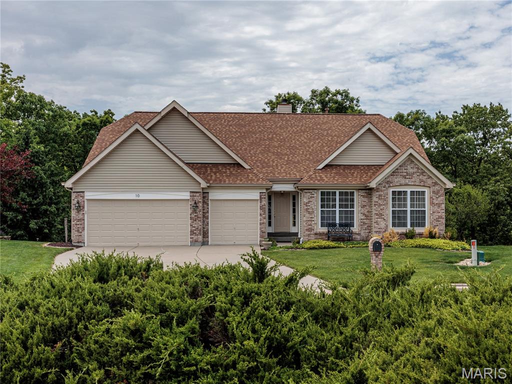 First Time Ever Offered By Its Original Owner, This Beautifully Maintained Home Is Tucked Into The Bluffs Above The Meramec River On A Quiet Cul-De-Sac In One Of Eureka's Most Sought-After Communities. Freshly Painted With Recently Deep-Cleaned Carpeting And A New Architectural Roof Installed In 2025, This Home Reflects All 26 Years Of Attentive Care And Pride Of Ownership.
A Hardwood Foyer Welcomes You Into An Open Floor Plan Where Soaring Cathedral Ceilings Create A Spacious, Airy Feel Throughout The Living, Dining, And Kitchen Areas. Luxury Vinyl Plank Flooring Spans Much Of The Main Level, While A Dramatic Wall Of Windows Fills This Atrium Ranch With Natural Light And Frames Peaceful Views Of The Private, Wooded Backyard.
The Living Room Is Anchored By A Wood-Burning Fireplace Featuring Custom Millwork And A Classic Brick Hearth. Designed For Both Entertaining And Everyday Living, The Kitchen Offers Abundant Oak Cabinetry, A Center Island With Gas Cooktop, A Wraparound Breakfast Bar, And Seamless Connection To The Dining And Living Areas. A Spacious Pantry And Laundry Room Combination Provides Extensive Shelving, Storage, And Convenient Main-Floor Washer And Dryer Connections. A Window Above The Sink Brings In Natural Light And Highlights The Surrounding Views.
The Impressive Primary Suite Features Vaulted Cathedral Ceilings, A Beautiful Bay Window Overlooking Mature Trees, Two Walk-In Closets, And A Generously Sized Private Bath Complete With Dual Sinks, Dedicated Vanity Area, Deep Soaking Tub, Separate Glass-Enclosed Shower, And Abundant Storage. Two Additional Main Level Bedrooms Offer Large Windows, Dual Closets, And Easy Access To A Well-Appointed Hall Bath.
The Finished Walk-Out Lower Level Expands The Living Space With A Spacious Family Room Featuring A Gas Fireplace, Wet Bar With Oak Cabinetry, Recessed Lighting, And Another Wall Of Windows Overlooking The Backyard. A Fourth Bedroom, Full Bath, Hobby Area With Workbench, Multiple Storage Spaces, And Additional Washer And Dryer Connections Provide Exceptional Flexibility For Guests, Hobbies, Or Multi-Generational Living.
Designed For Exceptional Indoor And Outdoor Living, The Home Features Walls Of Windows On Both Levels, A Low-Maintenance TimberTech Deck, Private Lower Deck, Spacious Concrete Patio, Aluminum Fencing, Landscaped Pathways, And Mature Trees That Create A Peaceful Backdrop With Very Little Visibility From Neighboring Properties. Whether Grilling, Entertaining, Or Simply Enjoying Nature, The Outdoor Spaces Offer Privacy And Versatility Rarely Found.
Additional Features Include A Three-Car Front-Entry Garage With Separate Automatic Openers, Direct Kitchen Access, Sprinkler System, Carrier Furnace With Aprilair Humidifier, And A Fifty-Gallon Gas Water Heater.
Residents Enjoy An Impressive Collection Of Neighborhood Amenities Including A Community Pool, Lake, Pond, Playground, Outdoor Fitness Stations, Tennis Courts, Pickleball Courts, Basketball Courts, Sand Volleyball Courts, And Snow Removal Services. The Nearby Legends Country Club And Golf Course Offer Additional Recreational Opportunities Through Optional Membership Programs. Conveniently Located Near Shopping, Dining, Parks, And Major Commuter Routes, This Is A Rare Opportunity To Own A Meticulously Cared For Home In An Exceptional Setting. Make Your Appointment And Write Your Offer Today!!