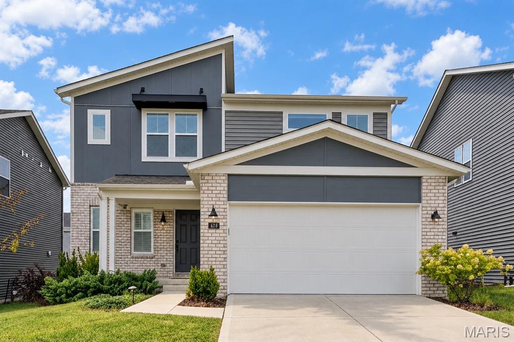Why wait months to build when this like-new, move-in-ready home—built in 2022—is ready for you now? Enjoy the benefits of newer construction without the delays or added expense of installing window treatments, building a composite deck, fencing the backyard or establishing a lawn and landscaping. This striking contemporary Craftsman-inspired elevation creates an impressive first impression with its asymmetrical roofline, mixed siding textures, white brick accents and modern black architectural details.  And if you think the exterior’s impressive, just wait until you see what’s inside!

This magazine worthy 3 bedrooms, 2.5 baths, features 9-foot main-level ceilings, neutral décor and luxury vinyl plank flooring throughout. The gourmet kitchen impresses with 42-inch Shaker cabinetry, beautiful quartz countertops, premium appliances and a spacious center island with sink and dishwasher. A designer wood-slat feature wall adds warmth and character to the inviting great room, while the breakfast room opens to the deck for effortless grilling, outdoor dining and entertaining. A private home office with glass-pane French doors, main-floor laundry and convenient powder room complete the main level.
Upstairs, a versatile bonus room with its own wood-slat feature wall provides additional space for relaxing, working or playing. The spacious primary suite offers a walk-in closet and private bath with an adult-height double vanity, oversized shower and transom window. Two generously sized secondary bedrooms—each with a walk-in closet—share a nearby full bath. The unfinished lower level, complete with an egress window, offers excellent potential for a fourth bedroom and additional living space.

Located in the highly sought-after Wentzville School District, Streets of Caledonia delivers a true resort-style lifestyle with an Olympic-size swimming pool, children’s splash pad, expansive clubhouse with full kitchen and fitness center, pickleball and bocce ball courts, playgrounds, scenic lakes and connecting walking trails. Convenient access to major highways, shopping, restaurants and everyday essentials makes this exceptional home as practical as it is beautiful. Refrigerator, washer and dryer included—just move in and enjoy!