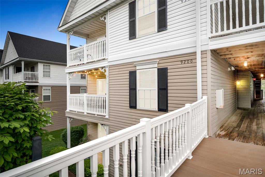 No stairs from the covered carport to the front door. Two bedrooms, two full baths, 1,014 square feet, all on a single level — the kind of layout that actually works for buyers, not just looks good in photos. End-unit position means more windows and more natural light, and you only share one wall with a neighbor.
Inside, real hardwood through the living and dining rooms, newer carpet in both bedrooms, and ceramic tile in the kitchen. Open floor plan, separate dining room, breakfast bar in the kitchen — flexible enough to set up however you live. The living area is pre-wired for surround sound. You'll find honest storage inside the unit and additional storage off the covered deck, which gives you a quiet spot for morning coffee.
The primary bedroom has a walk-in closet and a private full bath with a double vanity and lever-style faucets. Second bedroom plus second full bath gives you a true guest room, home office, or roommate setup — not just a glorified closet with a door. Laundry is in the unit, so no shared building laundry room and no hauling baskets up and down stairs.
Here's the part most condos at this price don't deliver: this one includes all the furniture and appliances with the property. That means refrigerator, range, oven, microwave, dishwasher, disposal, washer, dryer, plus all furniture if the buyer wants them. Show up with a suitcase and a toothbrush — you're moved in. If you'd rather bring your own stuff, that works too. Either way, there's nothing left to fix, paint, or update before you live here.
The monthly HOA covers grounds maintenance, parking and roads, snow removal, trash, water, and sewer. Community amenities include an in-ground pool, playground, dog park, basketball courts, walking trails, and a stocked pond for catch-and-release fishing. Plenty of guest parking above your assigned covered carport. 
Quick access to Highway 40/64 and Highway K means a simple commute to St. Charles, Chesterfield, Lake Saint Louis, or right back to downtown O'Fallon, where you've got real local restaurants, breweries, parks, and grocery stores within a few minutes' drive.